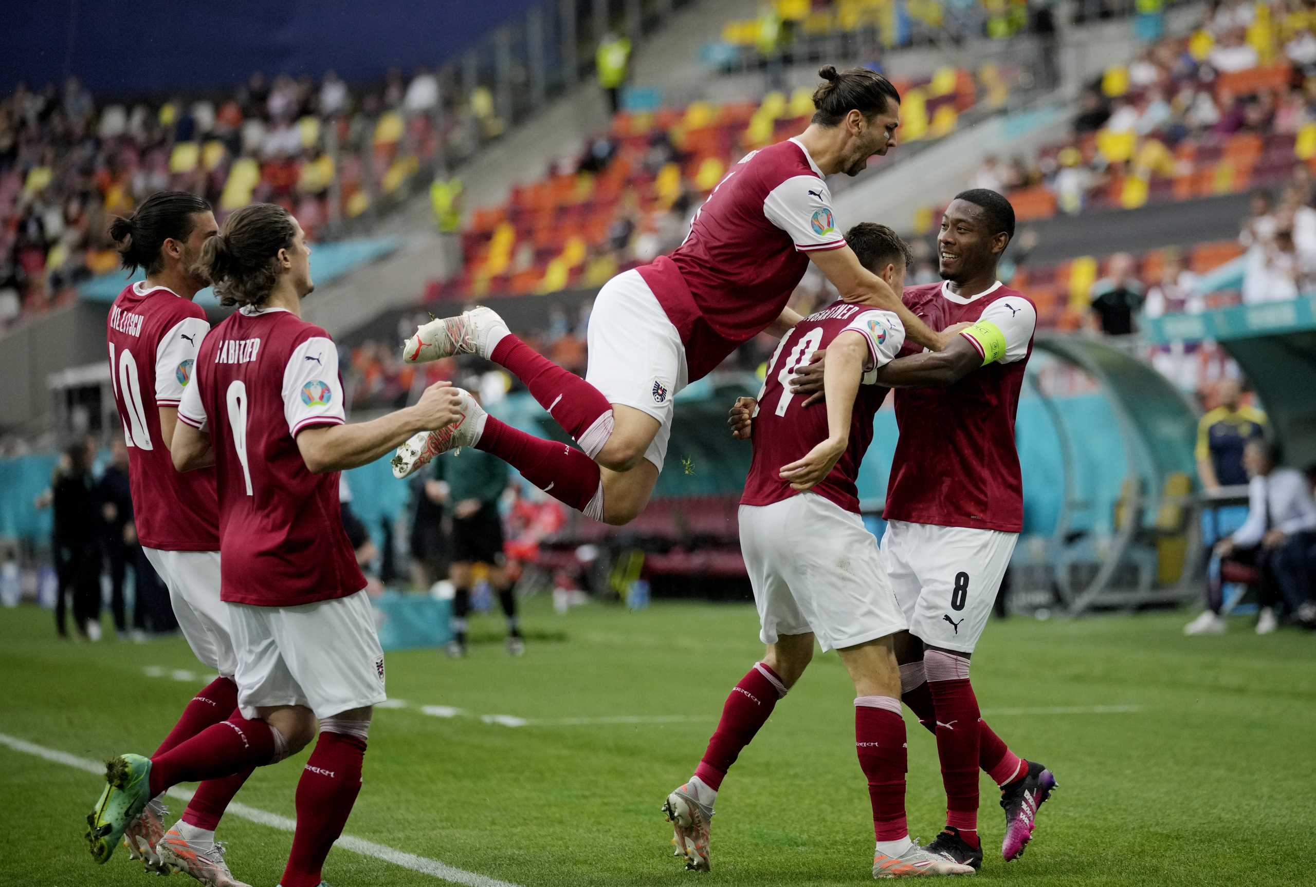 Soccer Football - Euro 2020 - Group C - Ukraine v Austria - National Arena Bucharest, Bucharest, Romania - June 21, 2021 Austria's Christoph Baumgartner celebrates scoring their first goal with teammates Pool via REUTERS