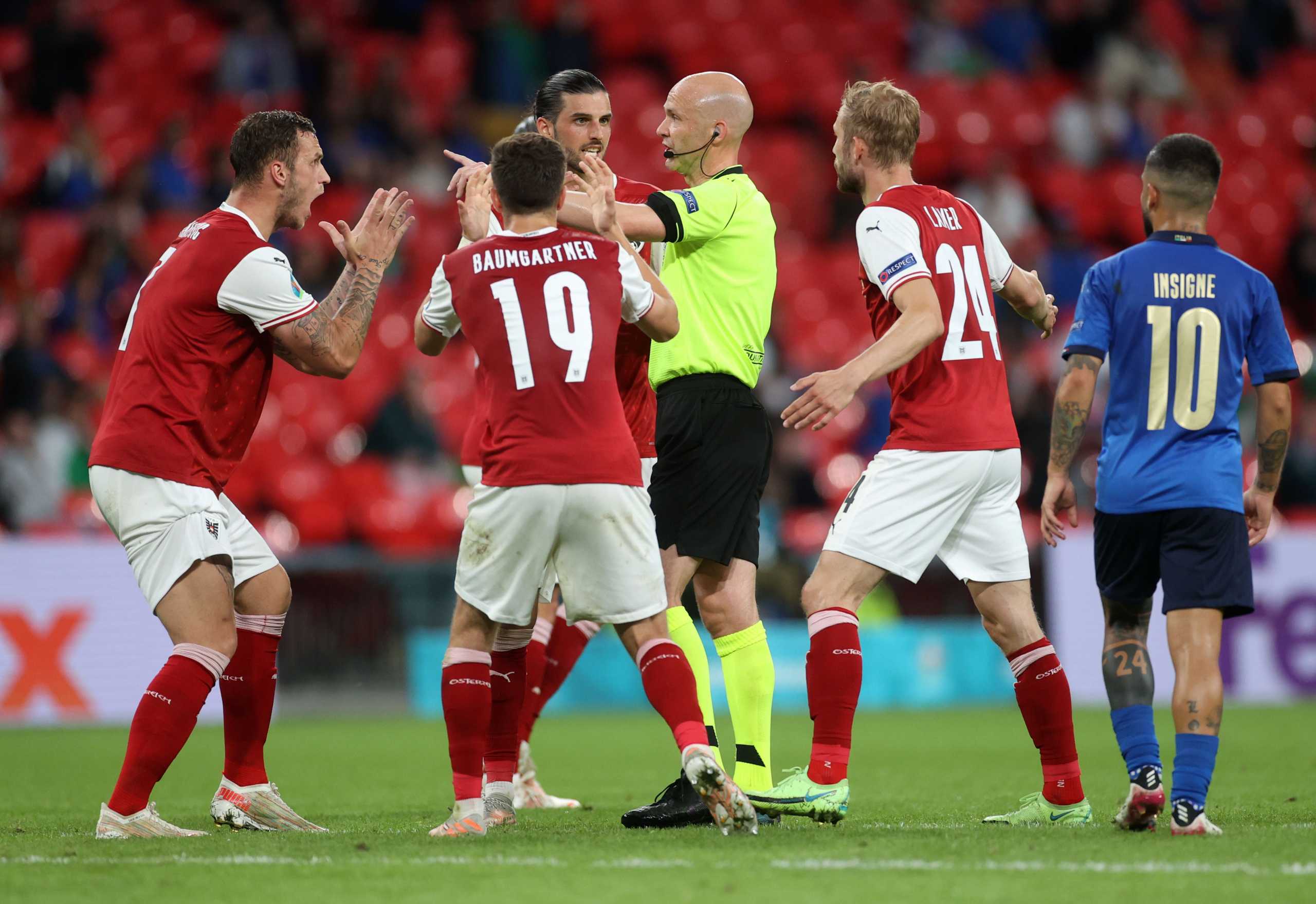 Soccer Football - Euro 2020 - Round of 16 - Italy v Austria - Wembley Stadium, London, Britain - June 26, 2021 Austria's Marko Arnautovic and teammates appeal for a penalty to referee Anthony Taylor Pool via REUTERS
