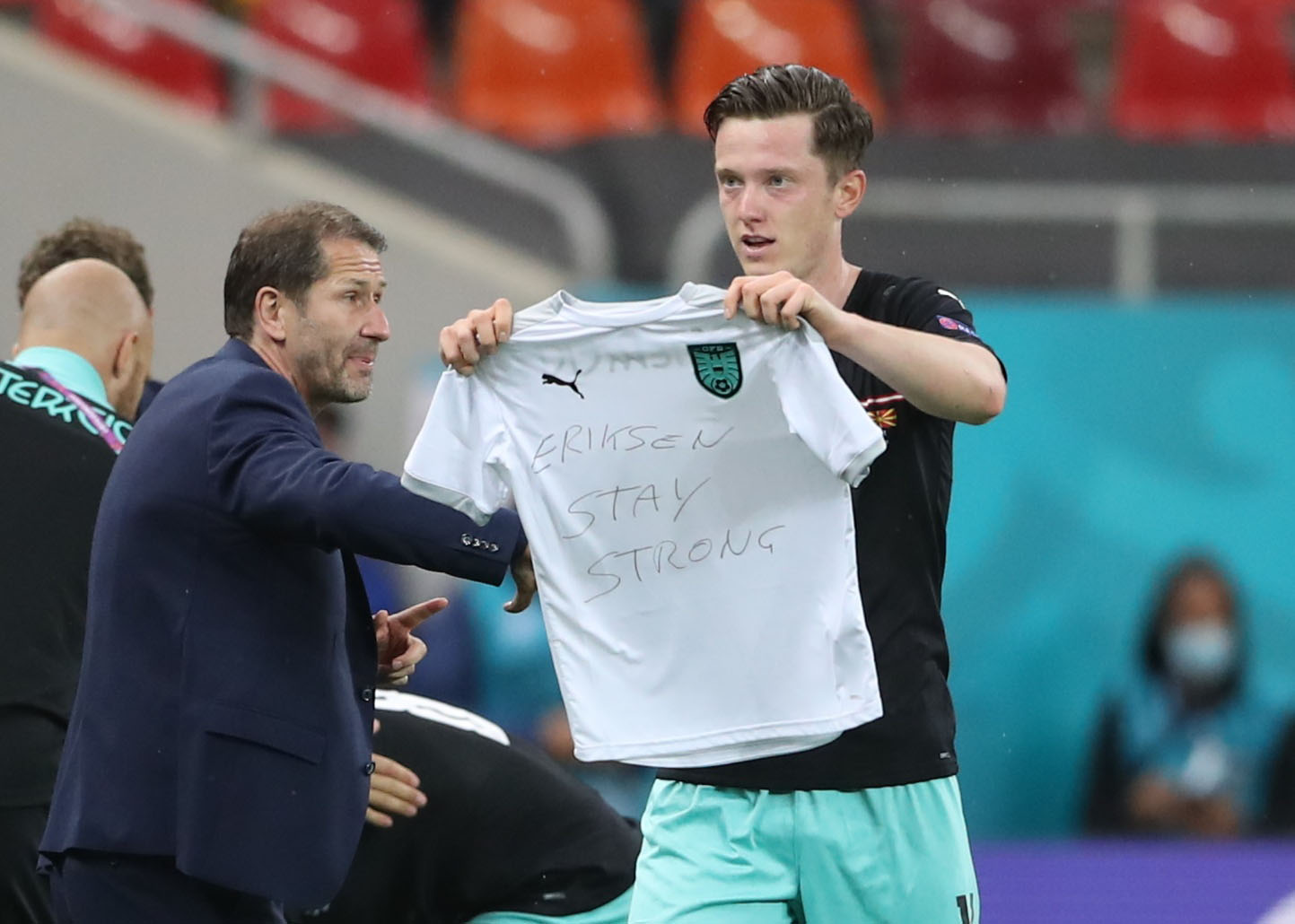 Soccer Football - Euro 2020 - Group C - Austria v North Macedonia - National Arena, Bucharest, Romania - June 13, 2021 Austria's Michael Gregoritsch celebrates scoring their second goal as he displays a message in support of Christian Eriksen Pool via REUTERS