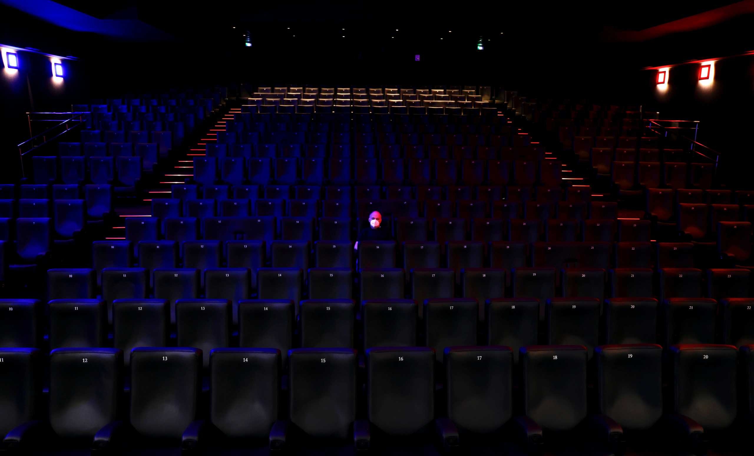 Thierry Duchene, owner of the Cinema Varietes, poses in an empty cinema room during preparations for its reopening in Nice as part of an easing of the country's lockdown restrictions amid the coronavirus disease (COVID-19) outbreak in France, May 18, 2021. REUTERS