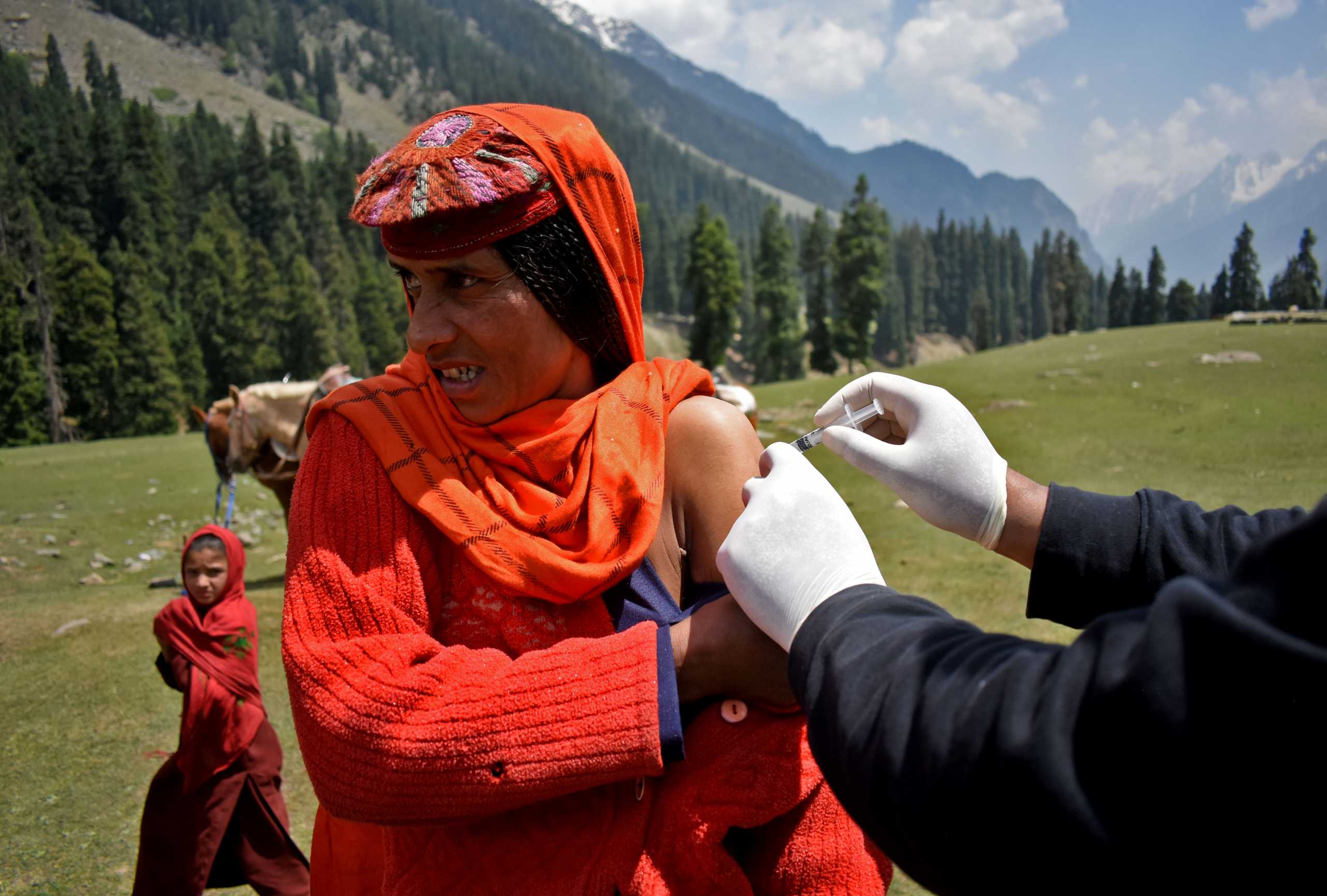 A shepherd woman receives a dose of COVISHIELD, a coronavirus disease (COVID-19) vaccine manufactured by Serum Institute of India, during a vaccination drive at Lidderwat near scenic Pahalgam in south Kashmir's Anantnag district, June 10, 2021. Picture taken June 10, 2021. REUTERS
