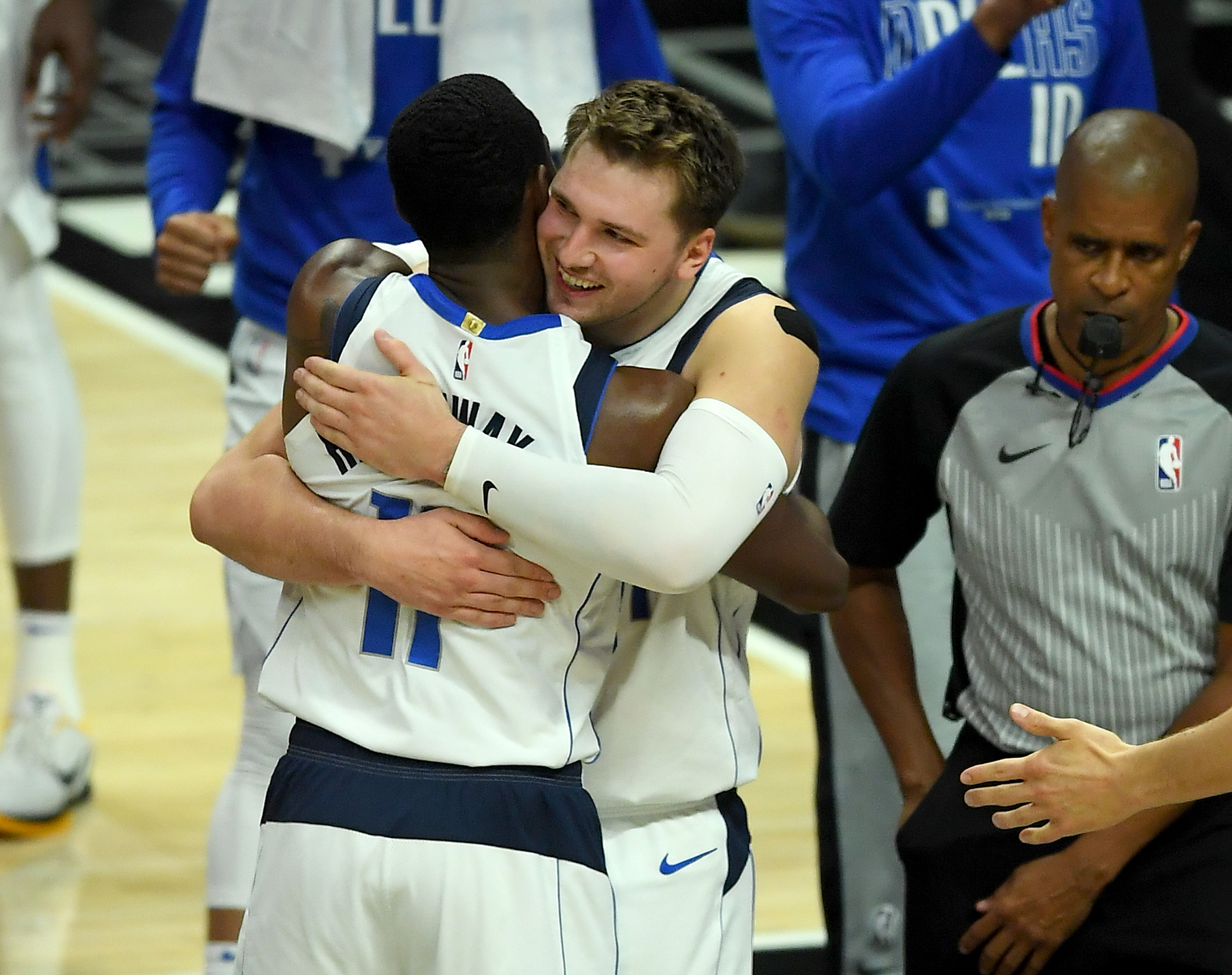 Jun 2, 2021; Los Angeles, California, USA;  Dallas Mavericks guard Luka Doncic (77) hugs forward Tim Hardaway Jr. (11) after defeating the Los Angeles Clippers in game 5 of round one of the 2021 NBA Playoffs at Staples Center. Mandatory Credit: Jayne Kamin-Oncea-USA TODAY Sports