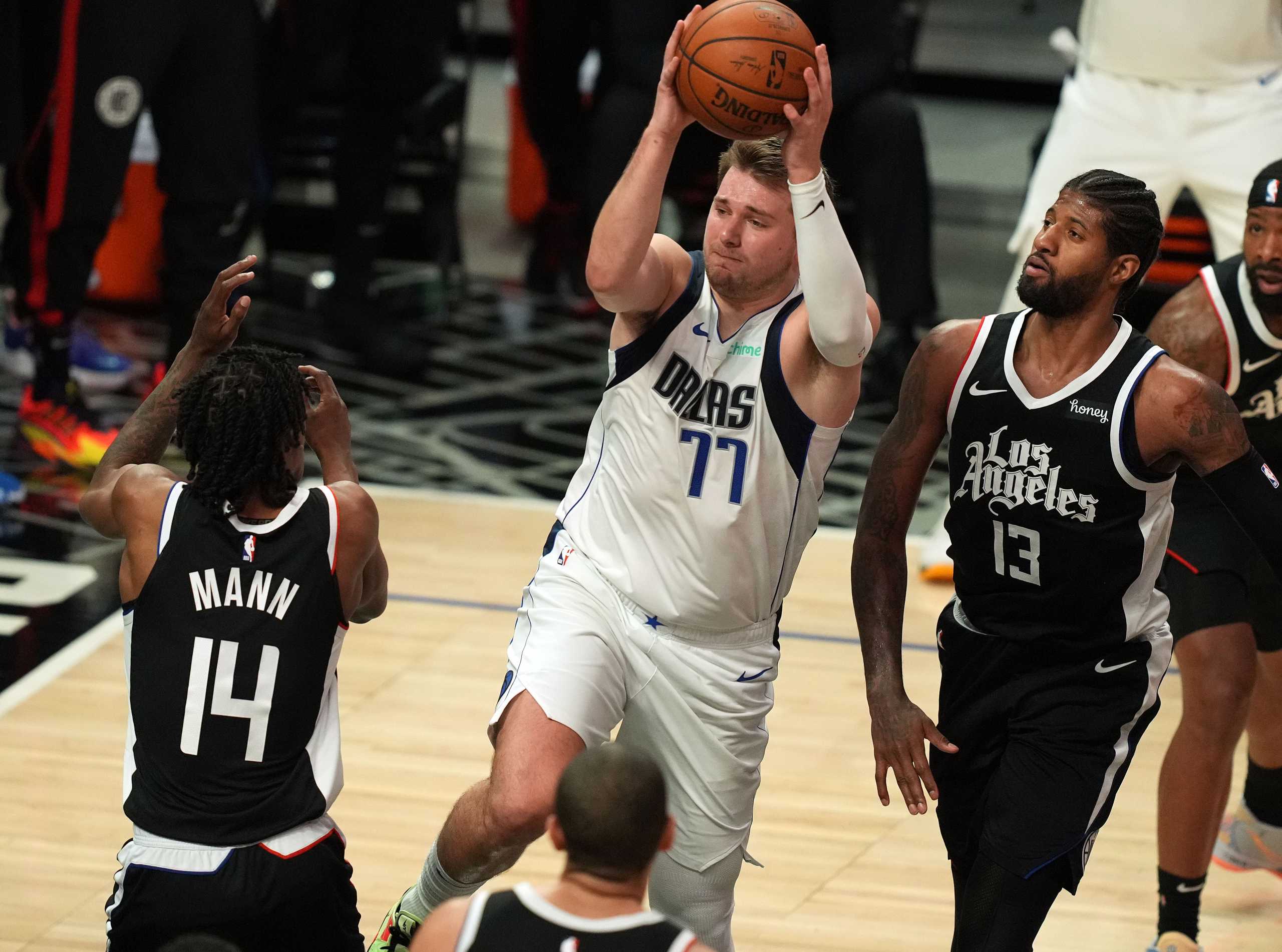 Jun 6, 2021; Los Angeles, California, USA; Dallas Mavericks guard Luka Doncic (77) controls the ball against Los Angeles Clippers guard Terance Mann (14) during the second half in game seven of the first round of the 2021 NBA Playoffs. at Staples Center. Mandatory Credit: Kirby Lee-USA TODAY Sports