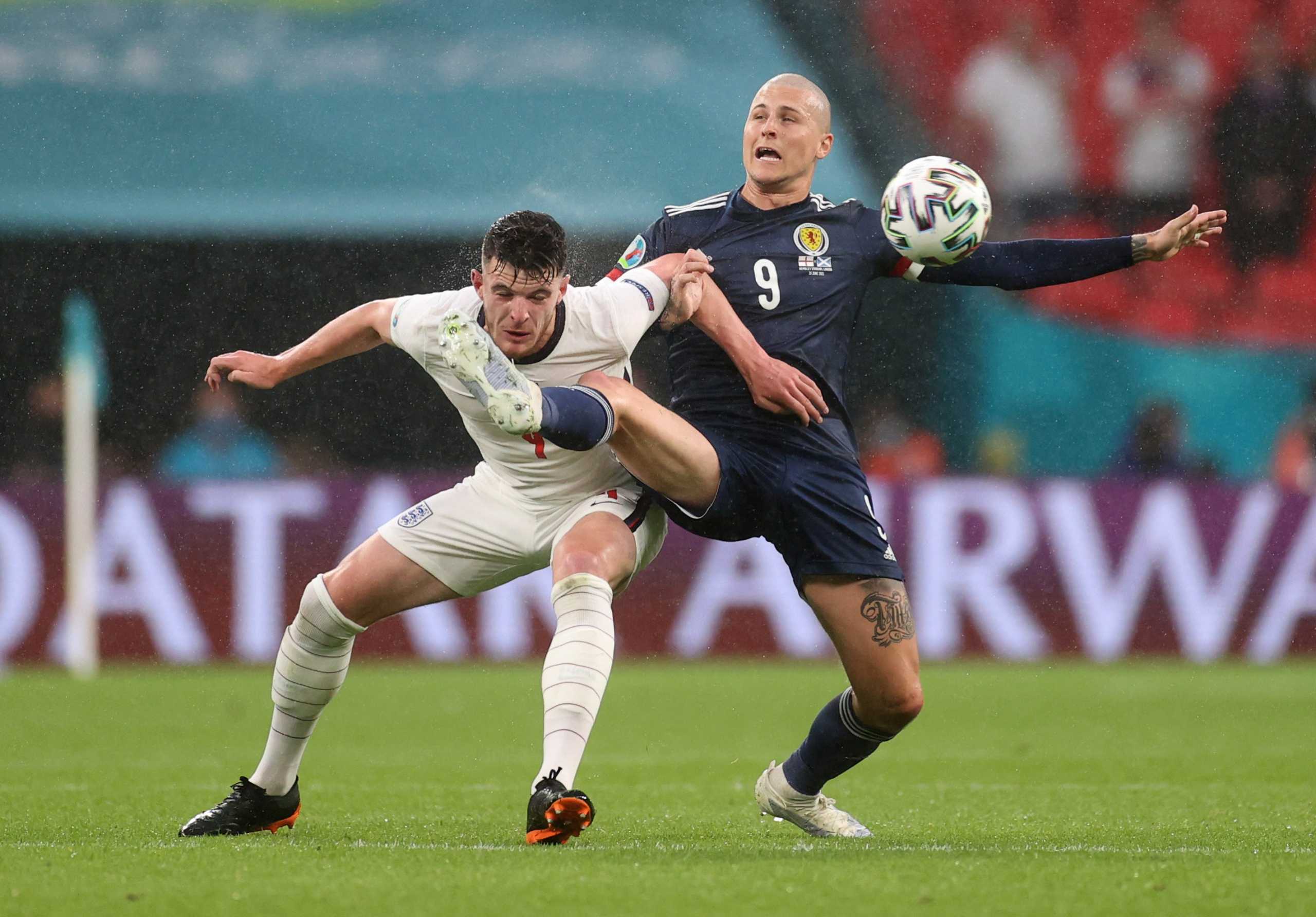 Soccer Football - Euro 2020 - Group D - England v Scotland - Wembley Stadium, London, Britain - June 18, 2021 Scotland's Lyndon Dykes in action with England's Declan Rice REUTERS