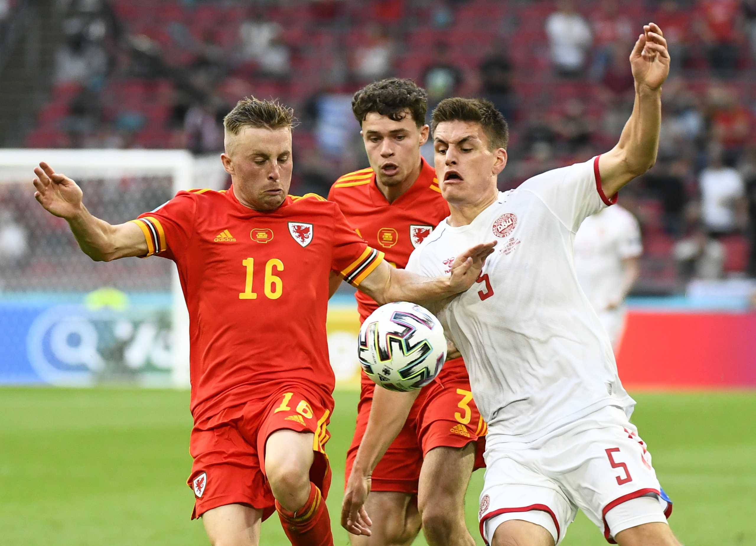 Soccer Football - Euro 2020 - Round of 16 - Wales v Denmark - Johan Cruijff ArenA, Amsterdam, Netherlands - June 26, 2021  Wales' Joe Morrell and Neco Williams in action with Denmark's Joakim Maehle Pool via REUTERS