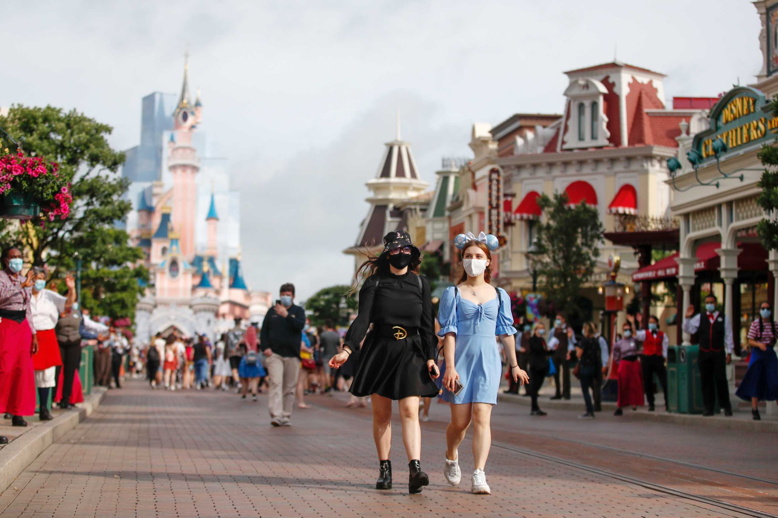 Visitors wear protective face masks at Disneyland Paris as the theme park reopens its doors to the public in Marne-la-Vallee, near Paris, following the coronavirus disease (COVID-19) outbreak in France, June 17, 2021. REUTERS
