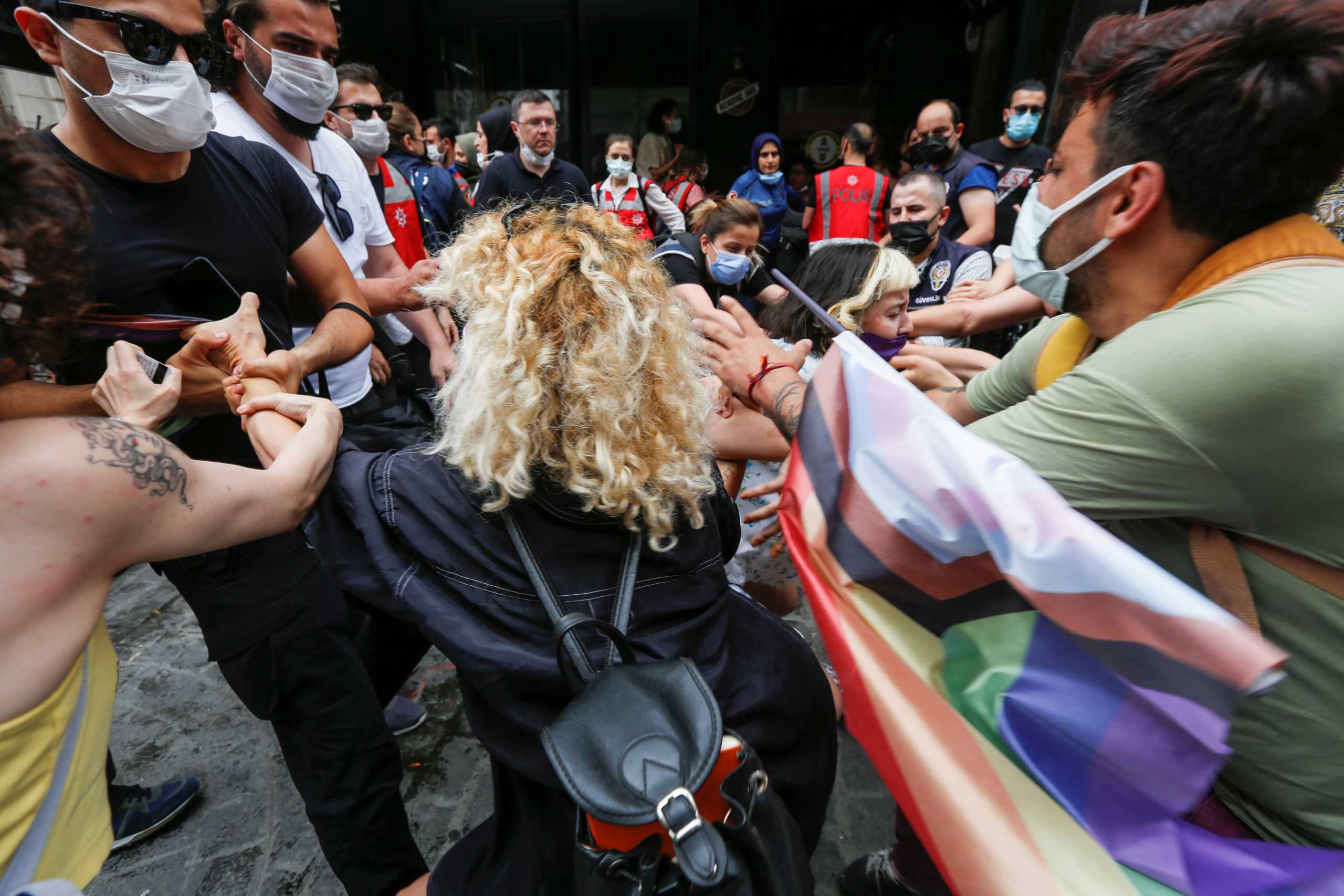 Demonstrators scuffle with plain-clothes police officers as they try to gather for a Pride parade, which was banned by local authorities, in central in Istanbul, Turkey June 26, 2021. REUTERS
