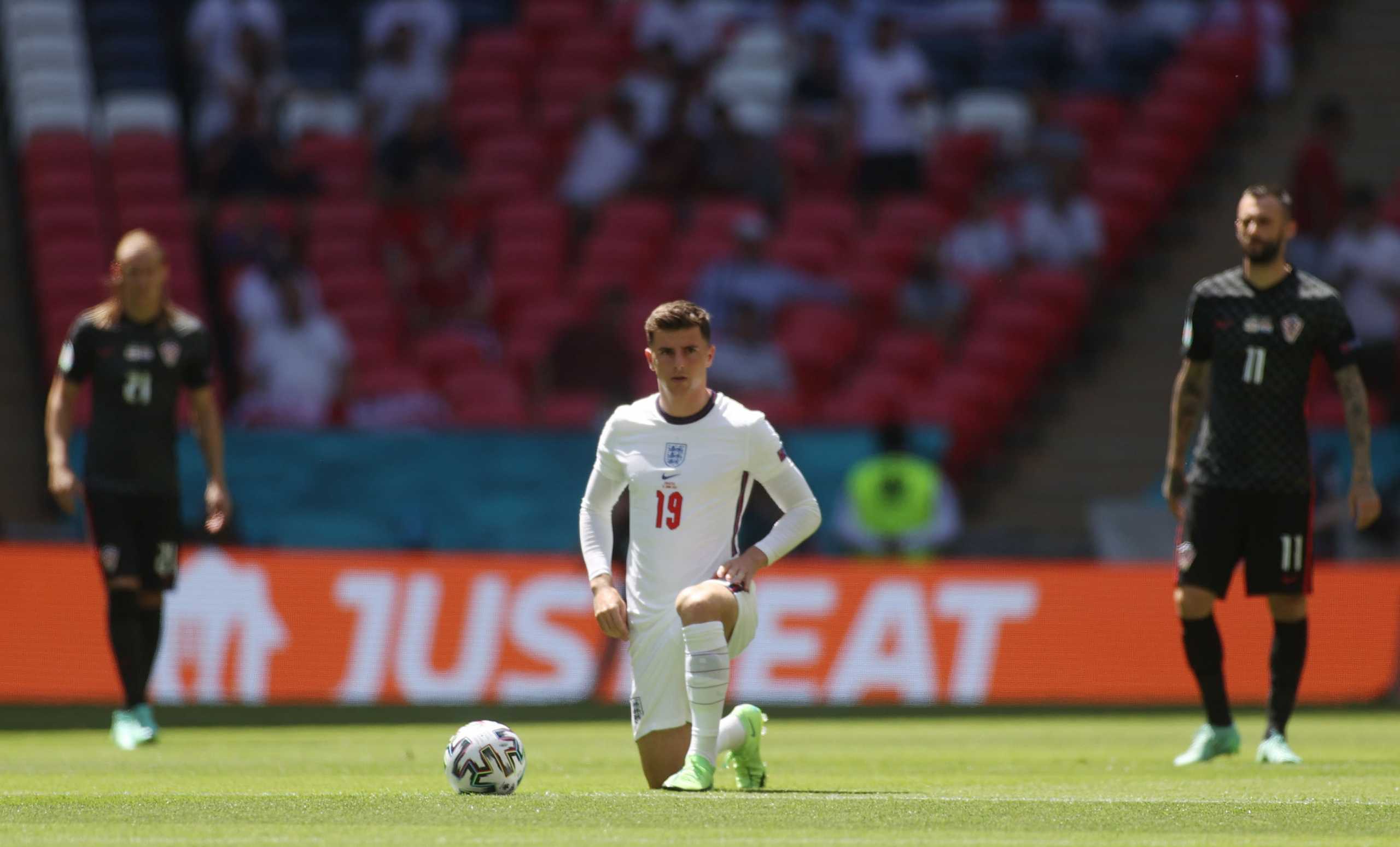 Soccer Football - Euro 2020 - Group D - England v Croatia - Wembley Stadium, London, Britain - June 13, 2021 England's Mason Mount takes the knee before the match Pool via REUTERS