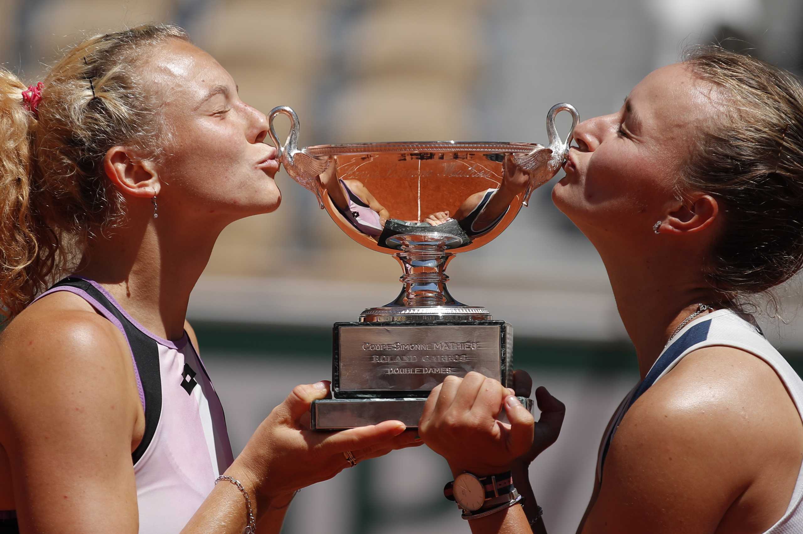 Tennis - French Open - Roland Garros, Paris, France - June 13, 2021 Czech Republic's Barbora Krejcikova and Katerina Siniakova celebrate with trophy after winning the women's doubles final against Poland's Iga Swiatek and Bethanie Mattek-Sands of the U.S. REUTERS