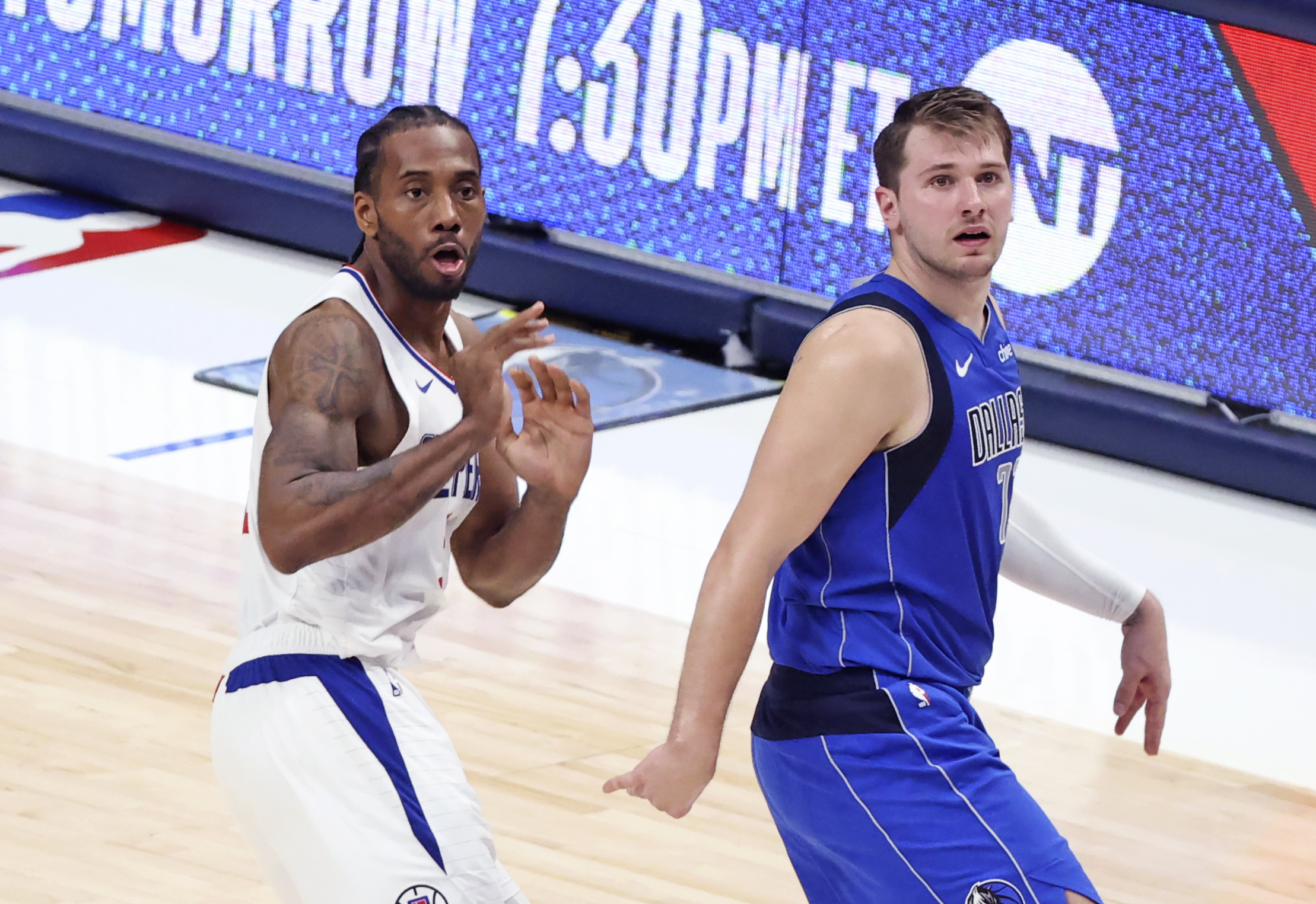 Jun 4, 2021; Dallas, Texas, USA; LA Clippers forward Kawhi Leonard (2) and Dallas Mavericks guard Luka Doncic (77) react after a Leonard shot during the fourth quarter during game six in the first round of the 2021 NBA Playoffs at American Airlines Center. Mandatory Credit: Kevin Jairaj-USA TODAY Sports