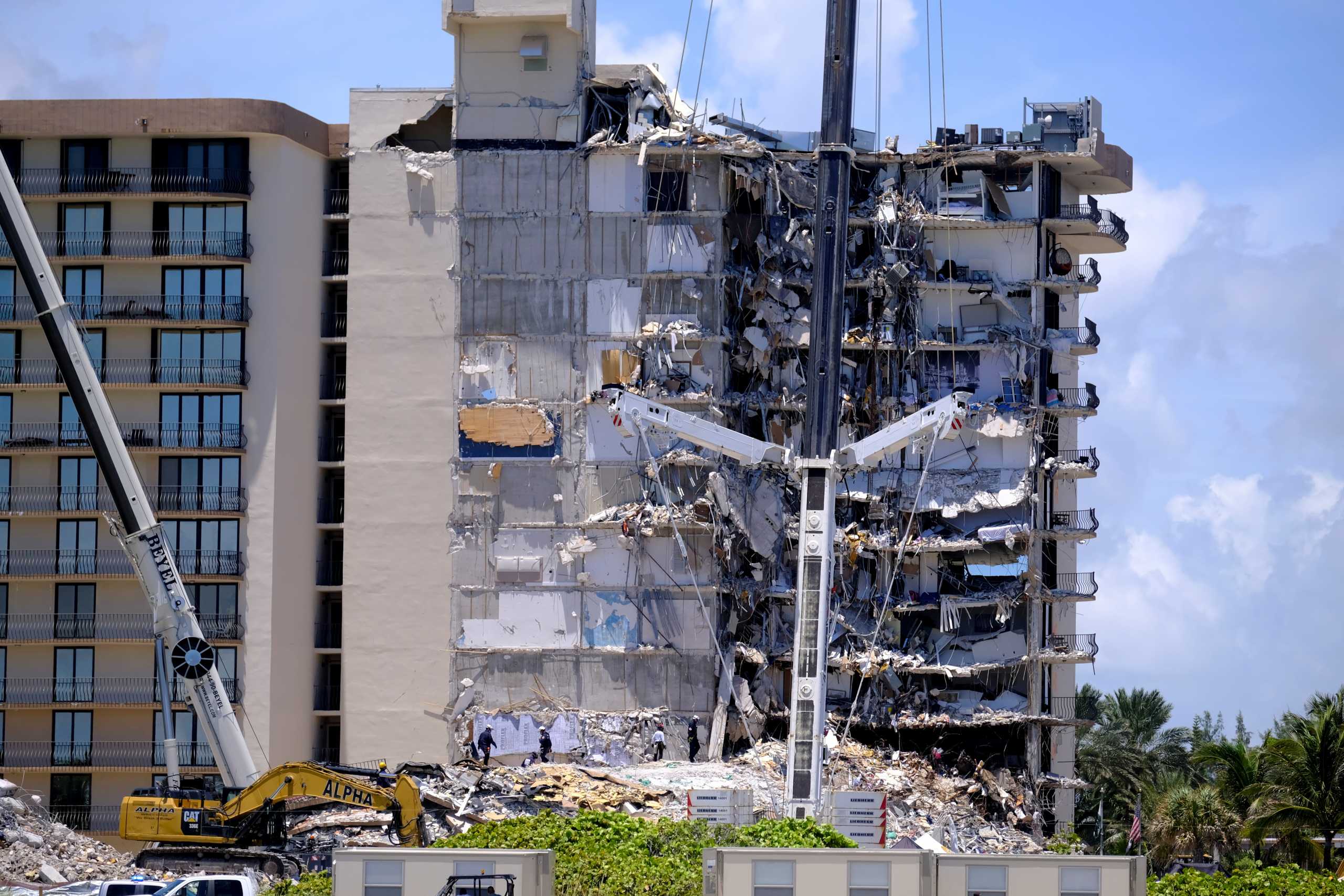 Search and rescue personnel continue searching for victims days after a residential building partially collapsed in Surfside near Miami Beach, Florida, U.S., June 27, 2021. REUTERS