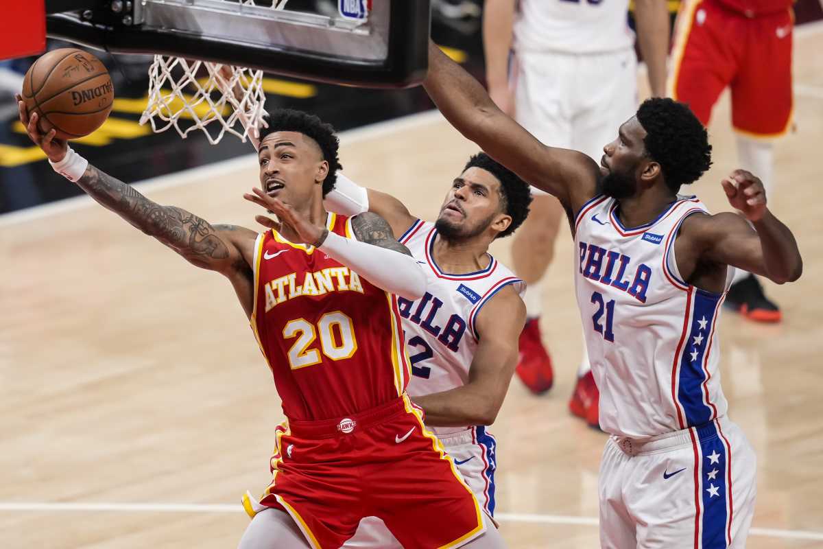 Jun 11, 2021; Atlanta, Georgia, USA; Atlanta Hawks forward John Collins (20) goes to the basket behind Philadelphia 76ers forward Tobias Harris (12) and center Joel Embiid (21) during the second half of game three in the second round of the 2021 NBA Playoffs. at State Farm Arena. Mandatory Credit: Dale Zanine-USA TODAY Sports
