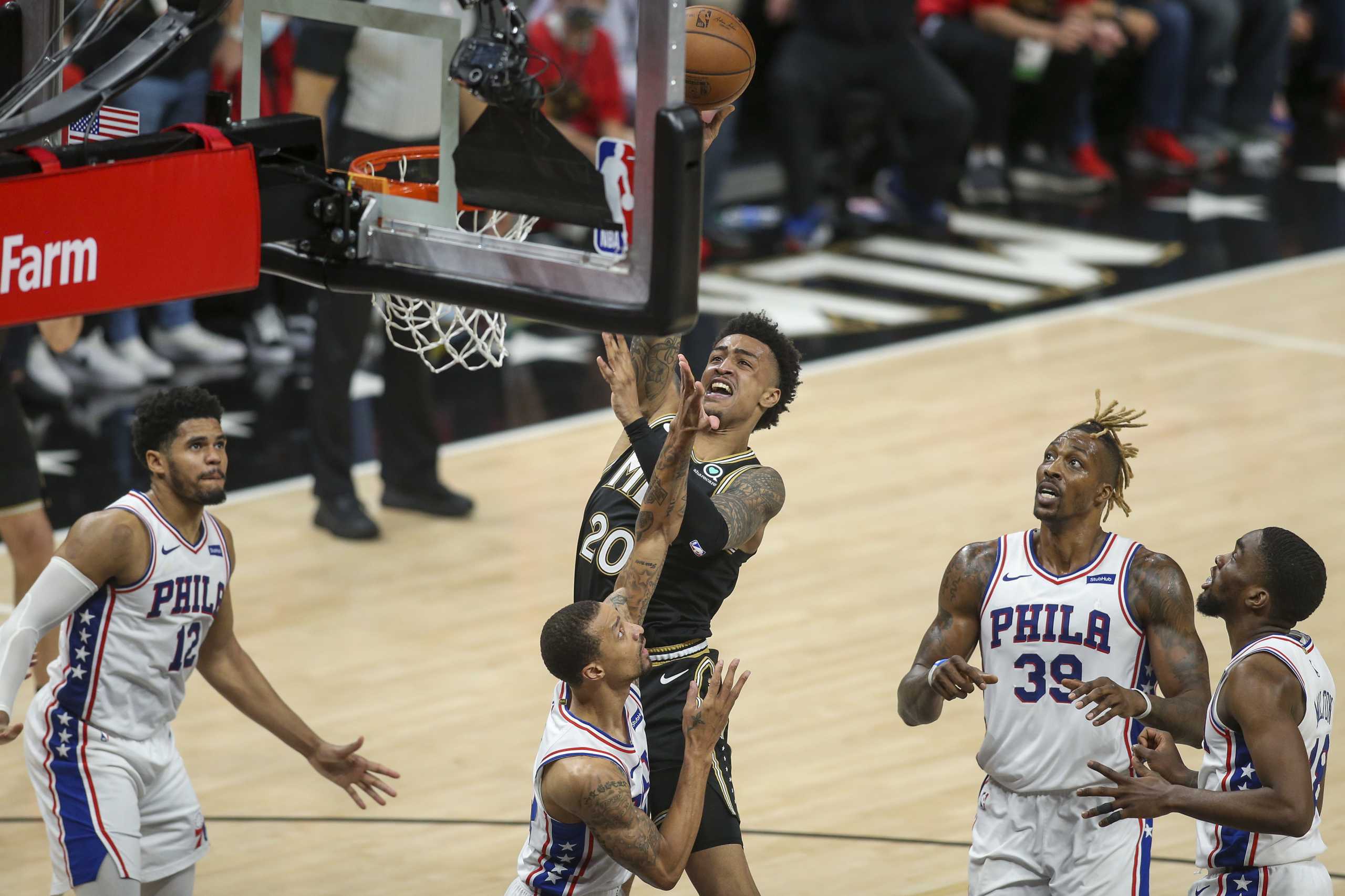 Jun 14, 2021; Atlanta, Georgia, USA; Atlanta Hawks forward John Collins (20) shoots over Philadelphia 76ers guard George Hill (33) in the fourth quarter during game four in the second round of the 2021 NBA Playoffs at State Farm Arena. Mandatory Credit: Brett Davis-USA TODAY Sports