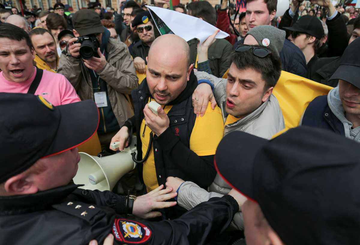 Andrei Pivovarov, member of Open Russia opposition group, stands in front of police officers during a demonstration on May Day in Saint Petersburg, Russia May 1, 2017. Picture taken May 1, 2017. REUTERS