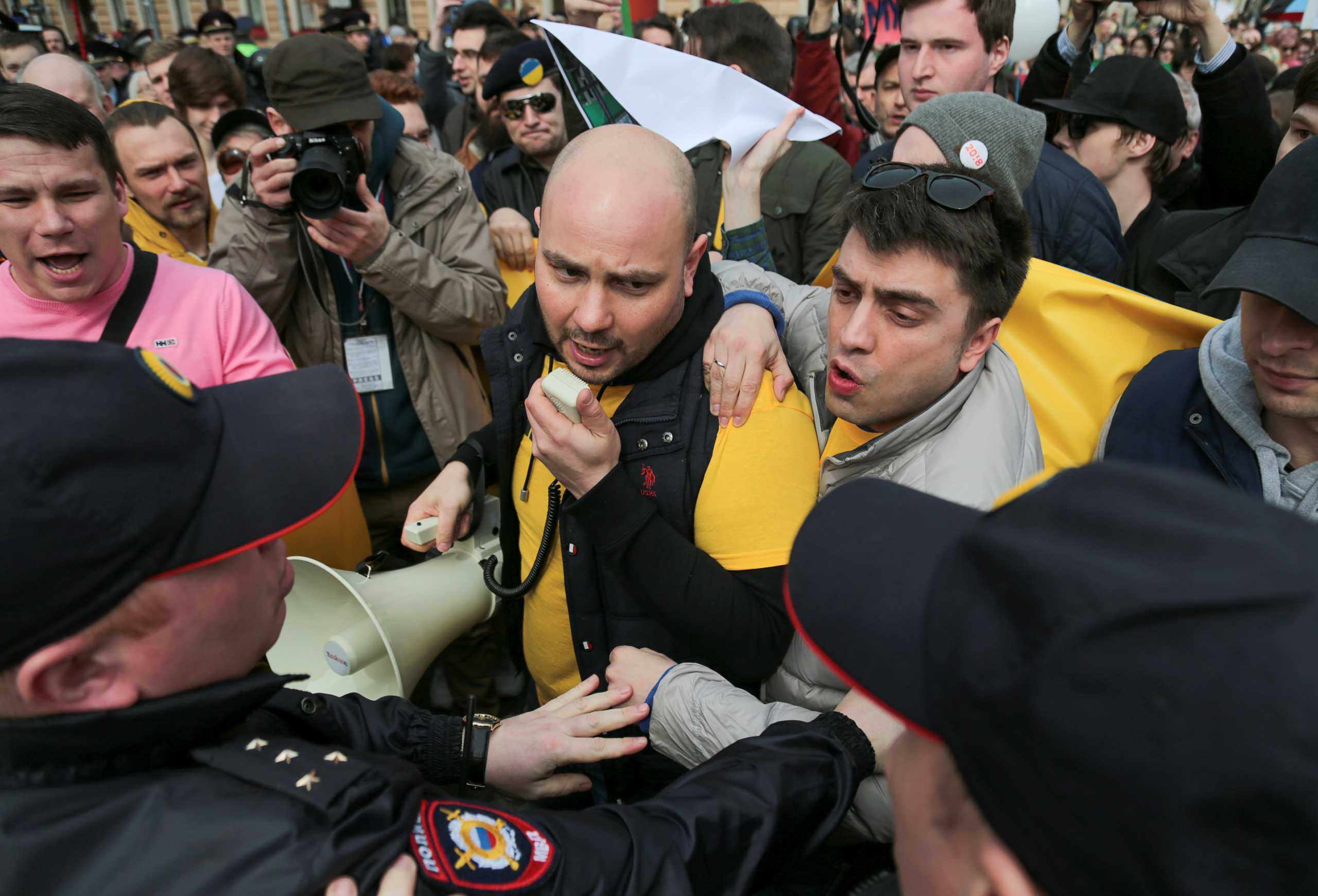 Andrei Pivovarov, member of Open Russia opposition group, stands in front of police officers during a demonstration on May Day in Saint Petersburg, Russia May 1, 2017. Picture taken May 1, 2017. REUTERS