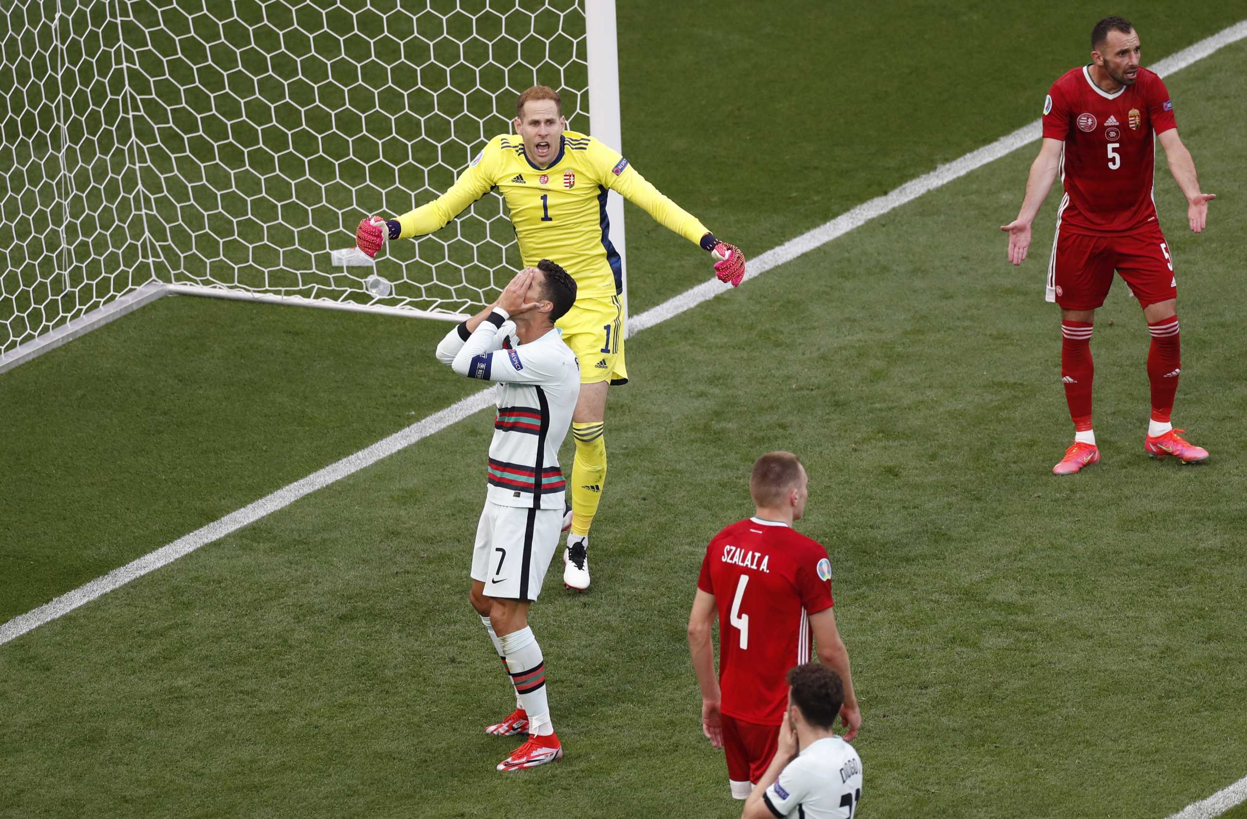 Soccer Football - Euro 2020 - Group F - Hungary v Portugal - Puskas Arena, Budapest, Hungary - June 15, 2021 Portugal's Cristiano Ronaldo looks dejected after a missed chance as Hungary's Peter Gulacsi reacts Pool via REUTERS