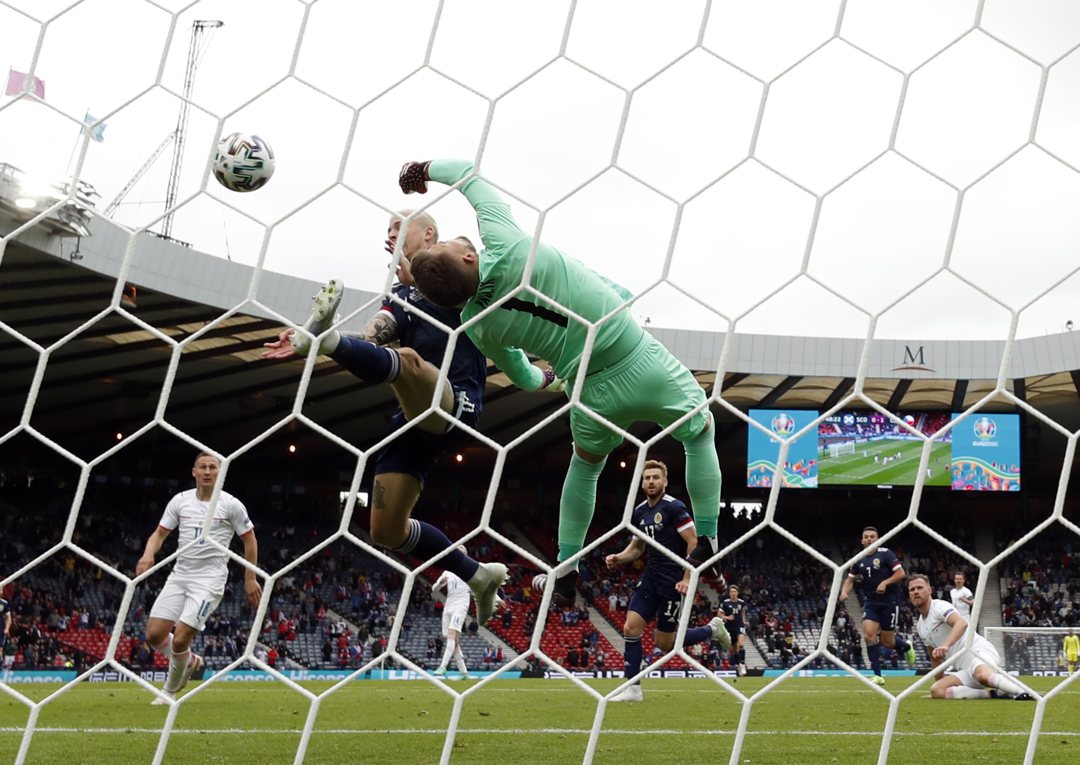 Soccer Football - Euro 2020 - Group D - Scotland v Czech Republic - Hampden Park, Glasgow, Scotland, Britain - June 14, 2021 Scotland's Lyndon Dykes in action with Czech Republic's Tomas Vaclik REUTERS