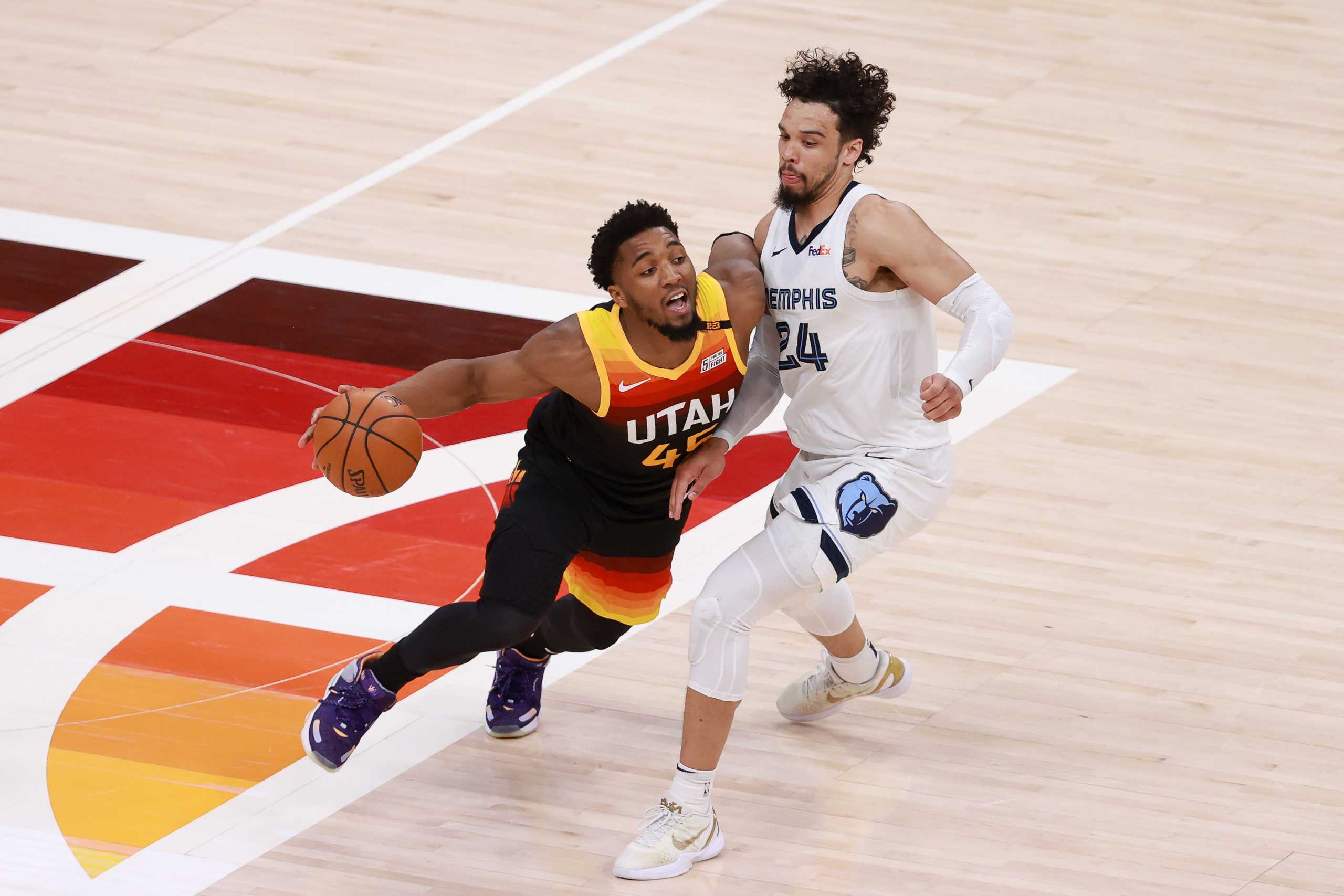 Jun 2, 2021; Salt Lake City, Utah, USA; Utah Jazz guard Donovan Mitchell (45) dribbles past Memphis Grizzlies forward Dillon Brooks (24) during the fourth quarter in game five of the first round of the 2021 NBA Playoffs at Vivint Arena. Utah Jazz win 126-110 and advance to the second round. Mandatory Credit: Chris Nicoll-USA TODAY Sports
