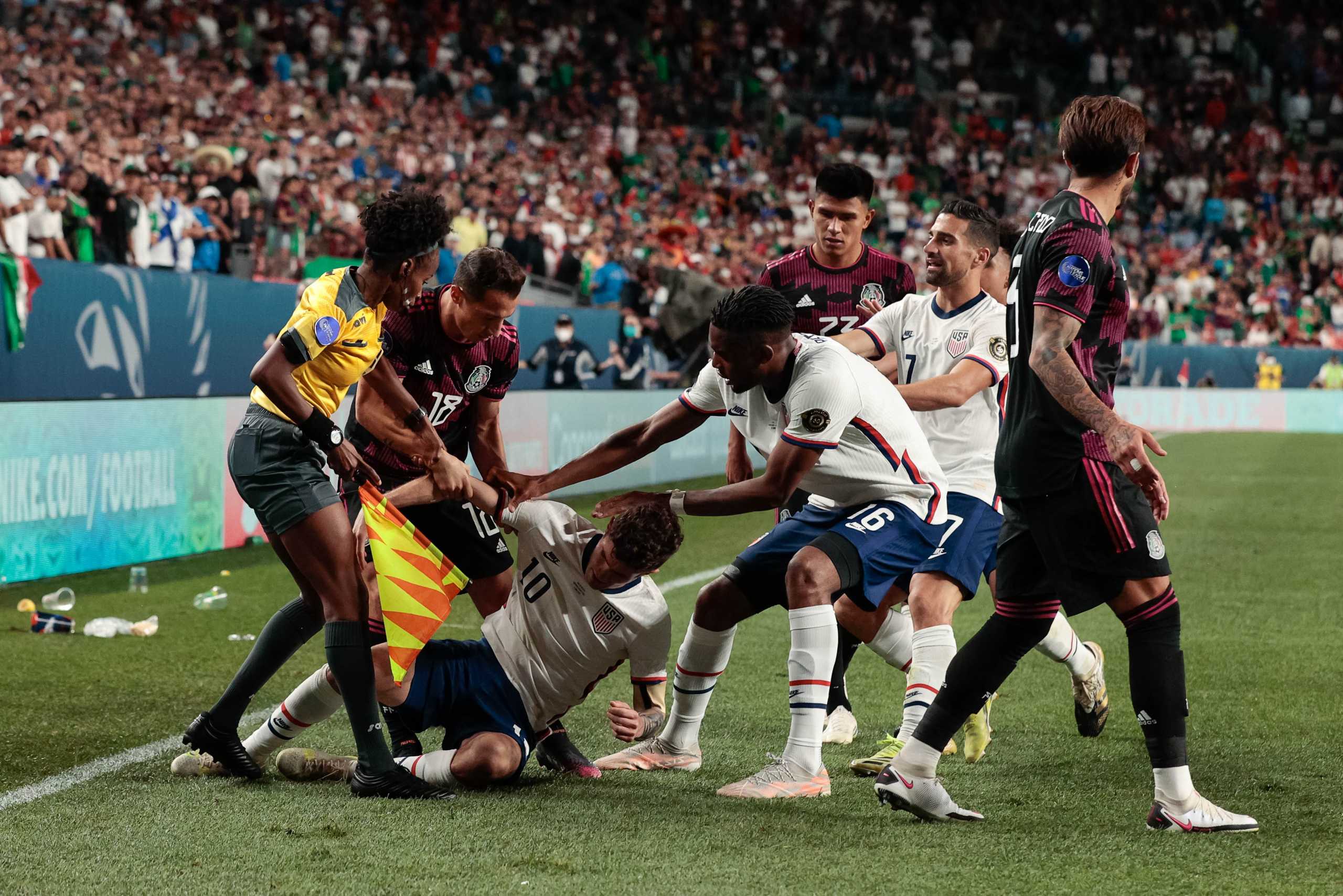 Jun 6, 2021; Denver, Colorado, USA; United States forward Jordan Siebatcheu Pefok (16) and midfielder Sebastian Lletget (17) react as Mexico midfielder Andres Guardado (18) pulls forward Christian Pulisic (10) as assistant referee Jassett Kerr intervenes in extra time during the 2021 CONCACAF Nations League Finals soccer series final match at Empower Field at Mile High. Mandatory Credit: Isaiah J. Downing-USA TODAY Sports