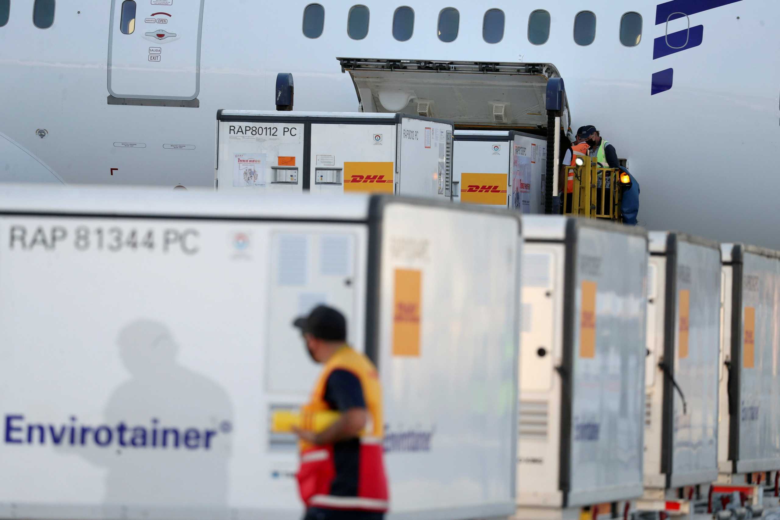 Workers unload containers with the first batch of China's CanSino COVID-19 vaccines at the Arturo Merino Benitez International Airport, as the coronavirus disease (COVID-19) outbreak continues, in Santiago, Chile May 28, 2021. REUTERS