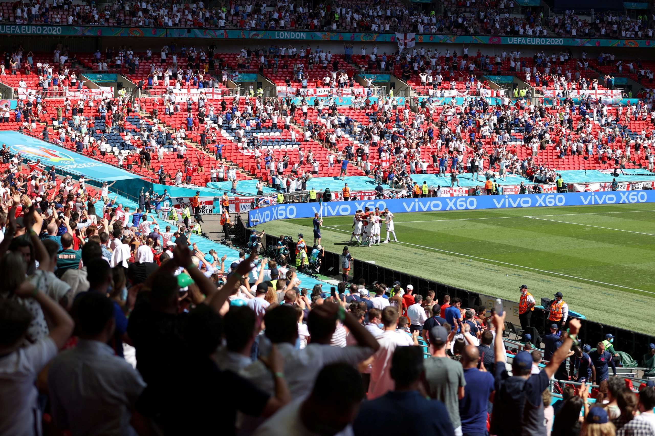 FILE PHOTO: Soccer Football - Euro 2020 - Group D - England v Croatia - Wembley Stadium, London, Britain - June 13, 2021 General view as England's Raheem Sterling celebrates scoring their first goal with team mates and fans Pool via REUTERS