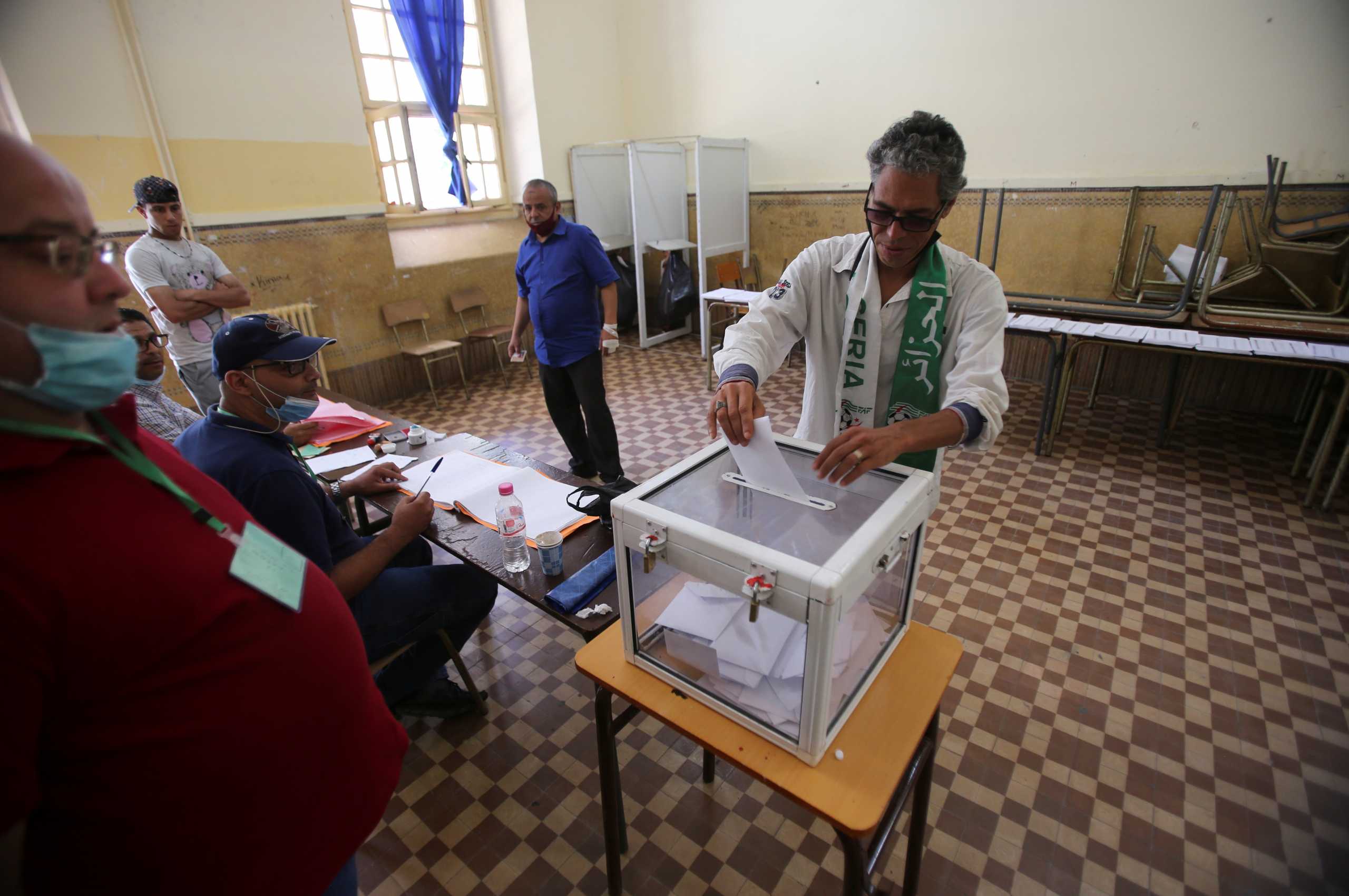 A man casts his vote at a polling station during the parliamentary election, in Algiers, Algeria June 12, 2021. REUTERS