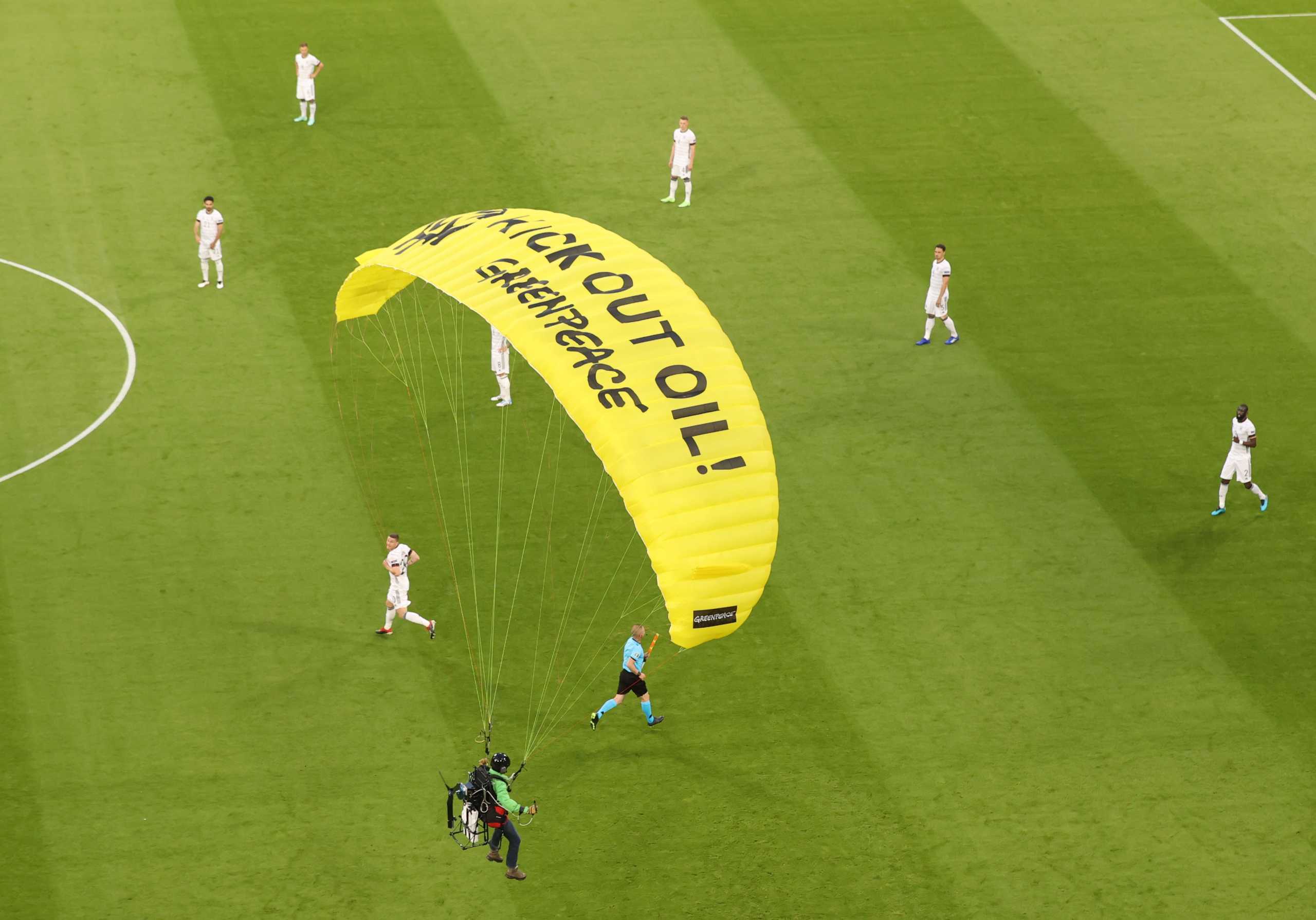 Soccer Football - Euro 2020 - Group F - France v Germany - Football Arena Munich, Munich, Germany - June 15, 2021 A Greenpeace protestor glides on to the pitch before the match Pool via REUTERS