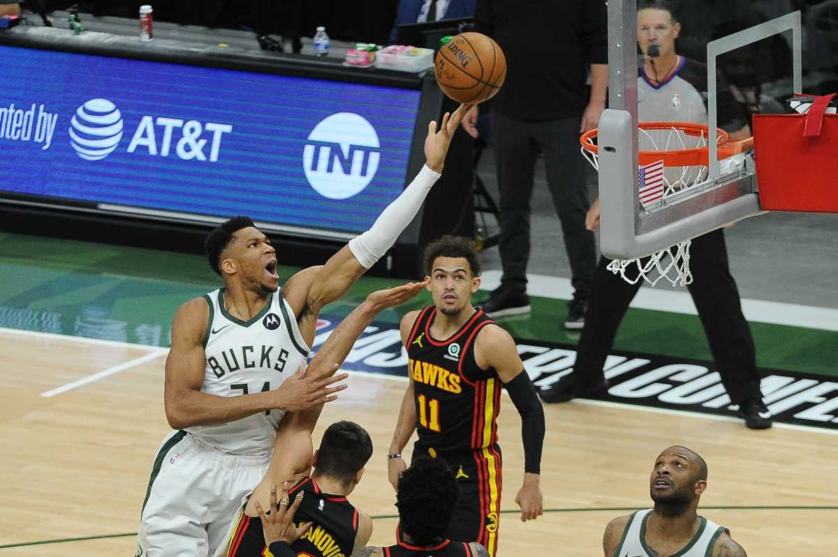 Jun 25, 2021; Milwaukee, Wisconsin, USA; Milwaukee Bucks forward Giannis Antetokounmpo (34) shoots the ball over Atlanta Hawks guard Bogdan Bogdanovic (13) in the first quarter during game two of the Eastern Conference Finals for the 2021 NBA Playoffs at Fiserv Forum. Mandatory Credit: Michael McLoone-USA TODAY Sports
