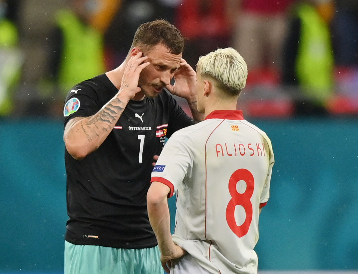 Soccer Football - Euro 2020 - Group C - Austria v North Macedonia - National Arena, Bucharest, Romania - June 13, 2021 Austria's Marko Arnautovic and North Macedonia's Ezgjan Alioski after the match Pool via REUTERS