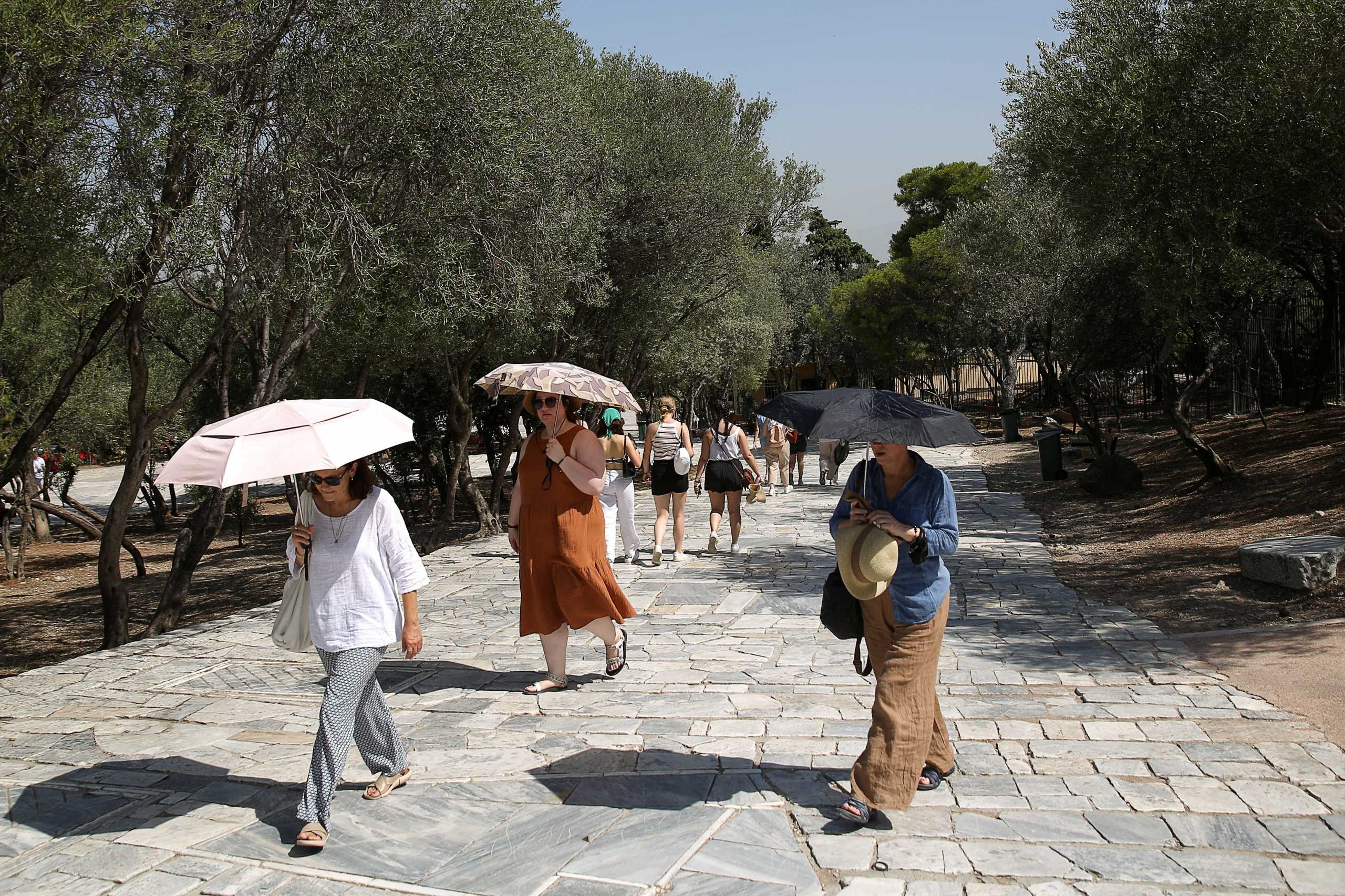 People without protective face masks make their way at an archaeological site of the Acropolis following the easing of measures against the spread of the coronavirus disease (COVID-19) in Athens, Greece, June 24, 2021. REUTERS