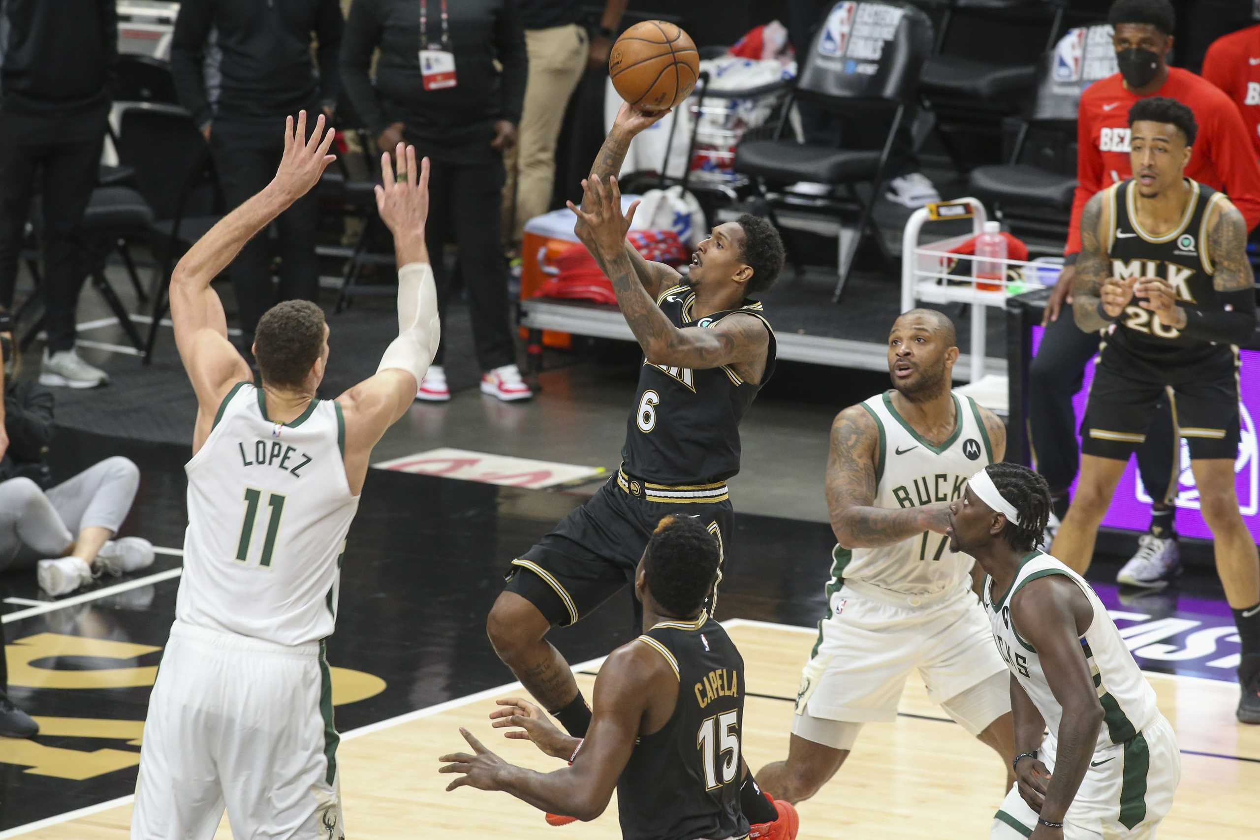 Jun 29, 2021; Atlanta, Georgia, USA; Atlanta Hawks guard Lou Williams (6) shoots over Milwaukee Bucks center Brook Lopez (11) in the third quarter during game four of the Eastern Conference Finals for the 2021 NBA Playoffs at State Farm Arena. Mandatory Credit: Brett Davis-USA TODAY Sports