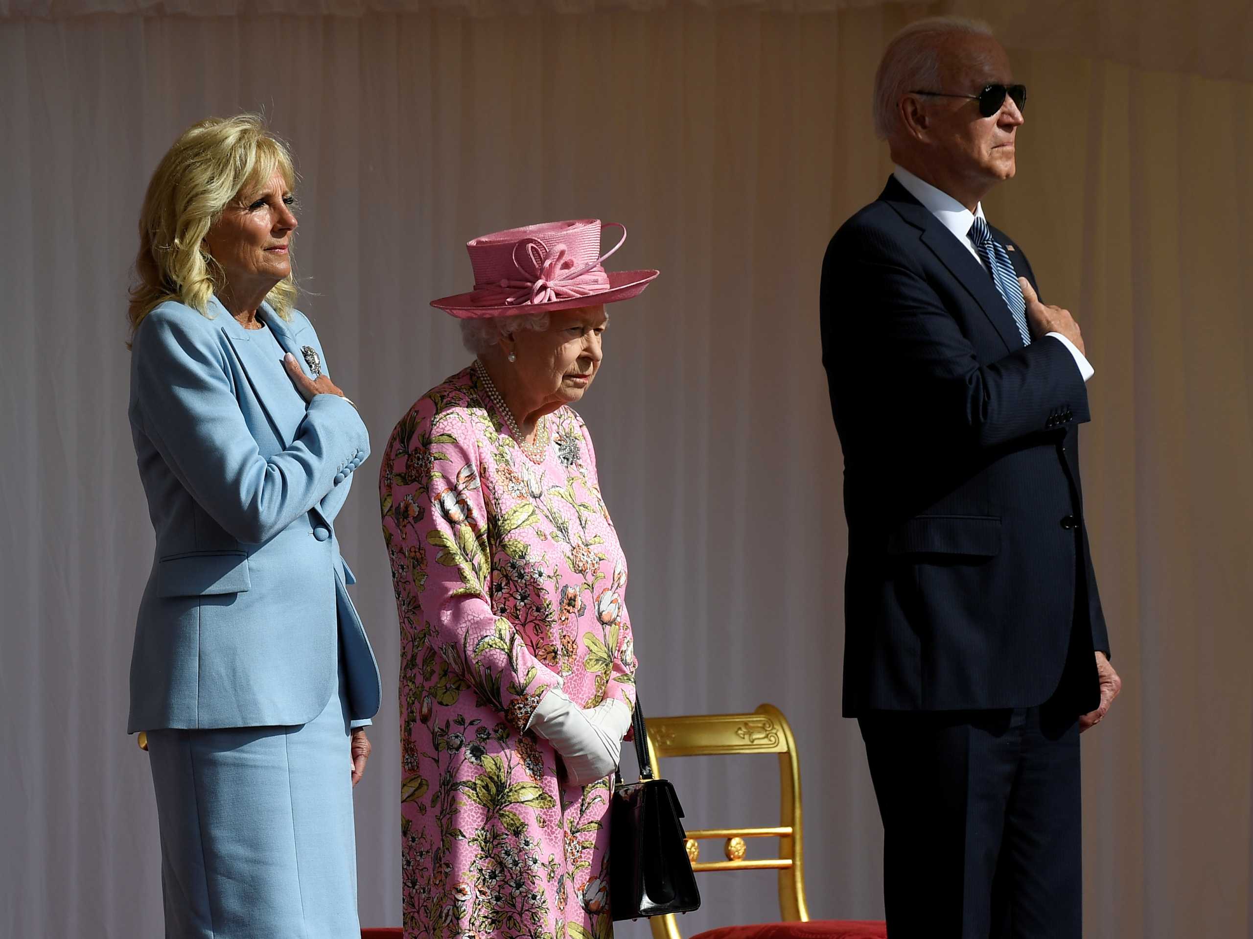 Britain's Queen Elizabeth II stands with U.S. President Joe Biden and first lady Jill Biden as they listen to the U.S. national anthem at Windsor Castle, in Windsor, Britain, June 13, 2021. Alberto Pezzali