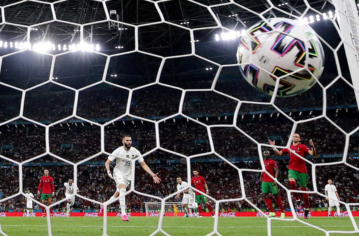 Soccer Football - Euro 2020 - Group F - Portugal v France - Puskas Arena, Budapest, Hungary - June 23, 2021 France's Karim Benzema celebrates scoring their first goal as Portugal's Pepe reacts REUTERS