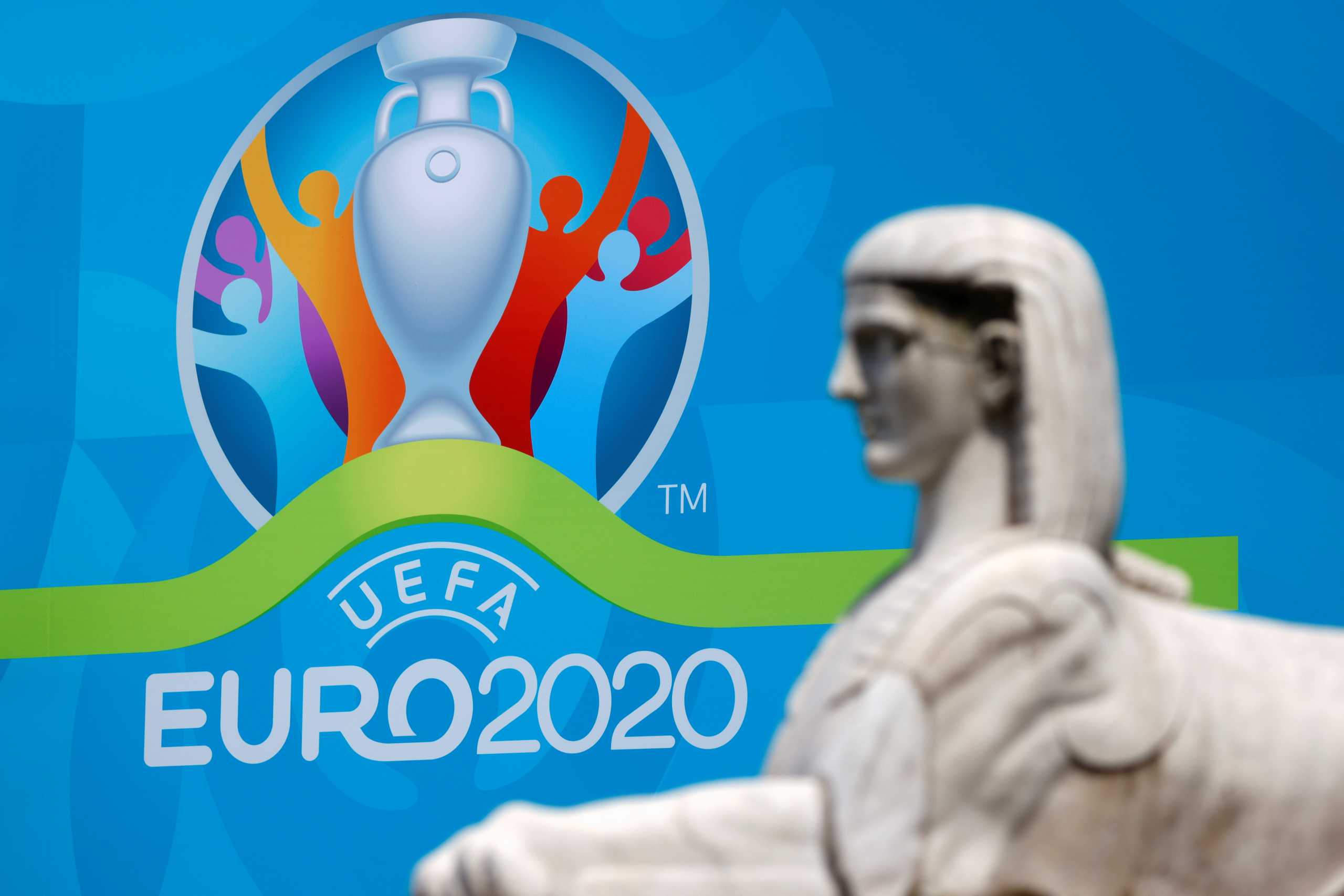 The logo of UEFA Euro 2020 is seen behind a statue at the fan zone at Piazza del Popolo in Rome, Italy, June 7, 2021. REUTERS