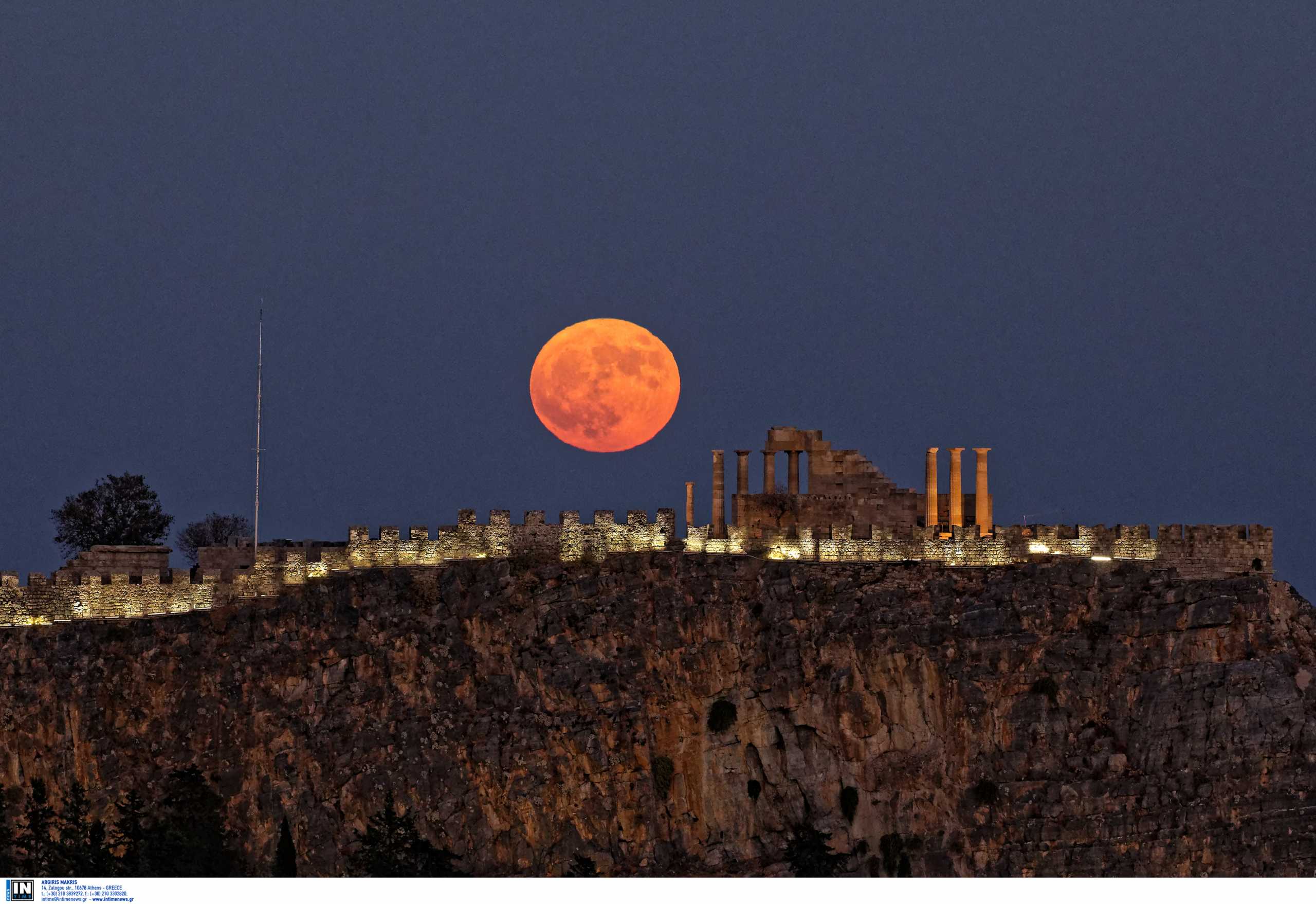 A full moon, known as a Halloween Blue Moon, is seen rising over ruins of the Acropolis of Lindos, 
a Doric temple built for Athena Lindia, the ancient goddess of wisdom, handicraft, and warfare, 
on the island of Rhodes, Greece, marking the end of the tourist season in the country which 
was affected by the Covid-19 Coronavirus pandemic. 1974 was the last time a blue moon was visible 
in the UK and Ireland and in 1944 was the last one visible across the whole world with the next one in 19 years. 
Saturday 31 October 2020