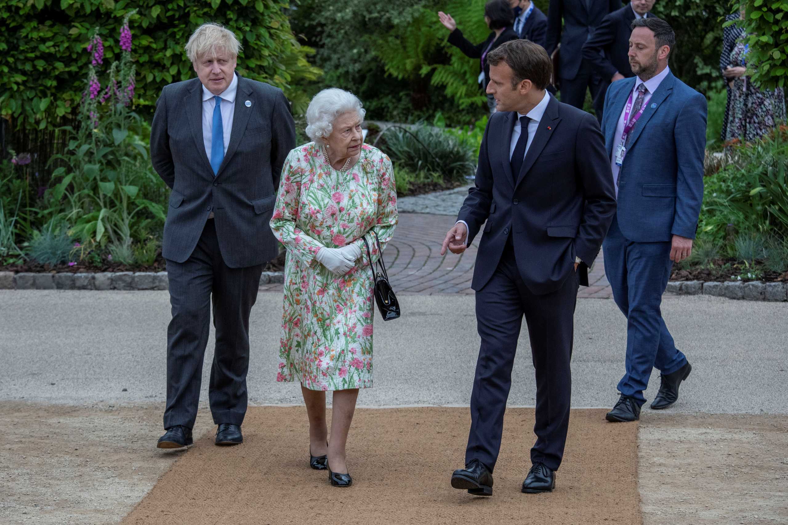 Britain's Queen Elizabeth, Britain's Prime Minister Boris Johnson and France's President Emmanuel Macron attend a drinks reception on the sidelines of the G7 summit, at the Eden Project in Cornwall, Britain June 11, 2021. Jack Hill