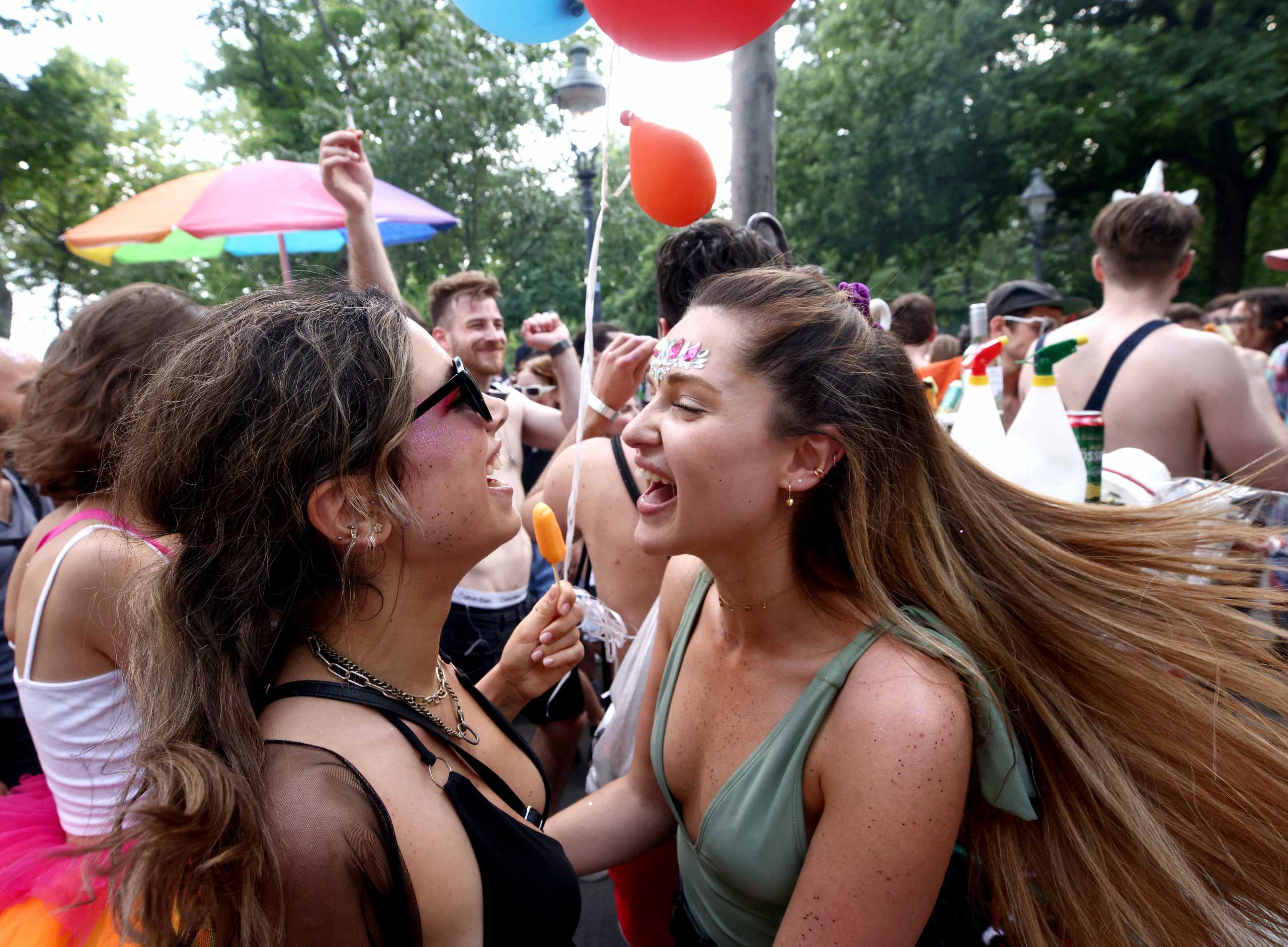 Revellers party as they attend the annual Rainbow Parade, a pride parade to support the rights of lesbian, gay, bisexual, transgender, intersex and queer (LGBTIQ) people in Vienna, Austria June 19, 2021. REUTERS