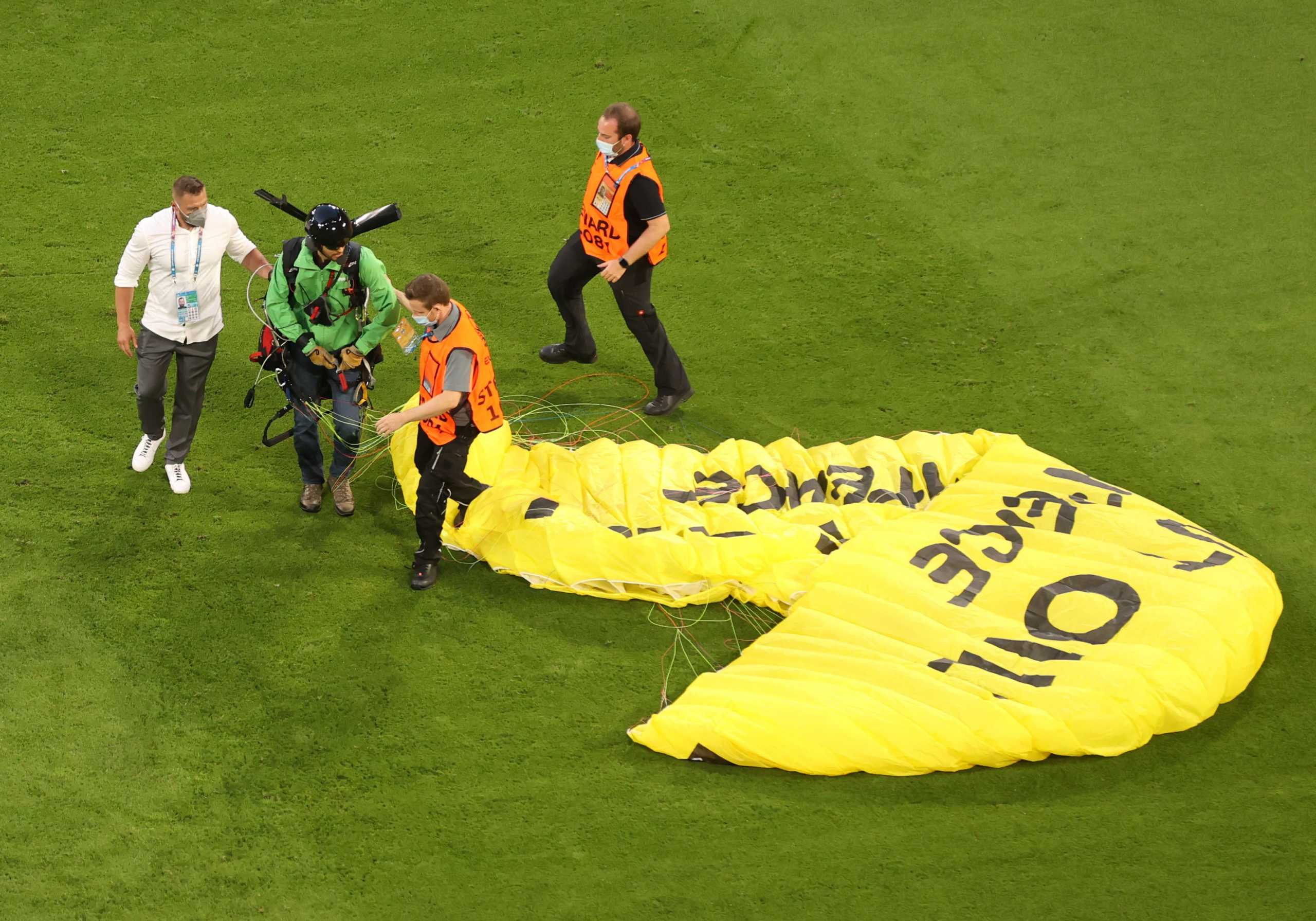 Soccer Football - Euro 2020 - Group F - France v Germany - Football Arena Munich, Munich, Germany - June 15, 2021 A Greenpeace protestor glides on to the pitch before the match Pool via REUTERS