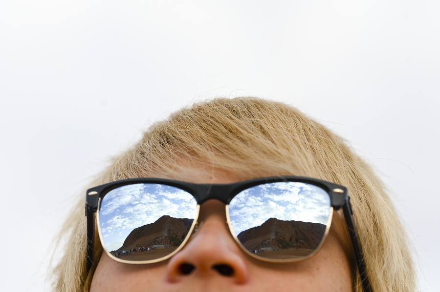 epa07932405 A view of Uluru, Australia's iconic sandstone formation, as seen reflected in a tourist's sunglasses in Uluru-Kata Tjuta National Park in Northern Territory, Australia, 13 October 2019 (issued 19 October 2019). Tourists have been flocking to Uluru ahead of the enforcement of a climbing ban, which was announced on 01 November 2017. The decision was made by the traditional owners of the land and the Uluru-Kata Tjuta National Park board and will become effective on 26 October 2019.  EPA