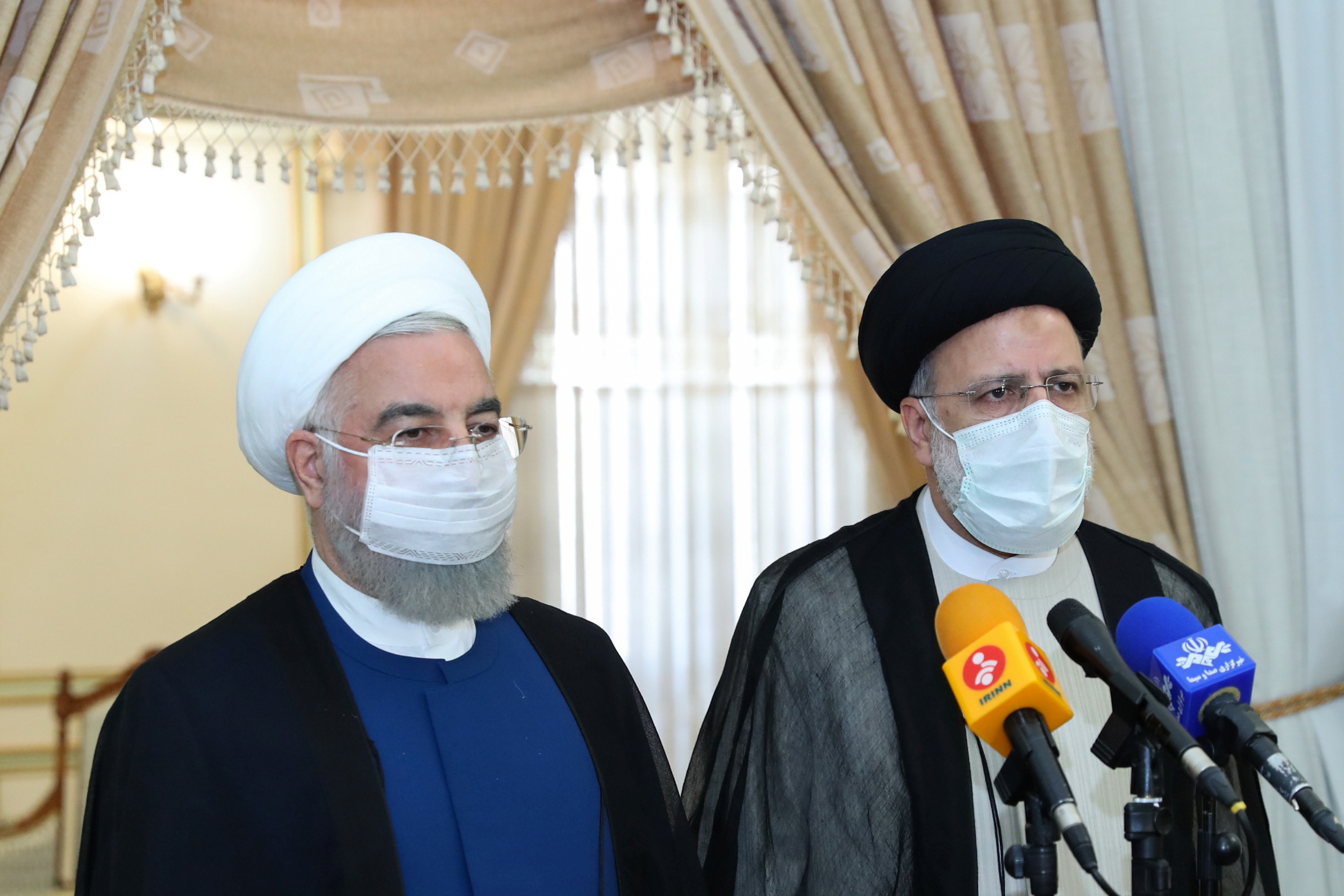 Iran's outgoing President Hassan Rouhani and Iran's President-elect Ebrahim Raisi speak to the media after their meeting in Tehran, Iran June 19, 2021. Official Presidential website