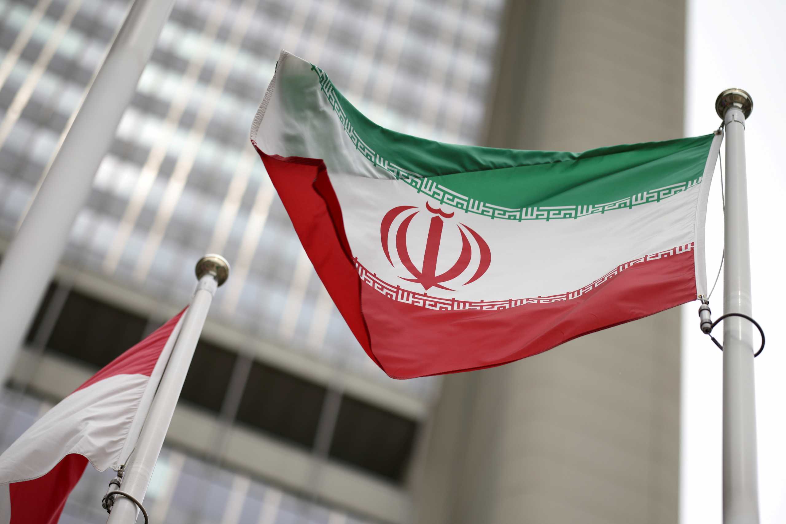 FILE PHOTO: Iranian flag flies in front of the UN office building, housing IAEA headquarters, amid the coronavirus disease (COVID-19) pandemic, in Vienna, Austria, May 24, 2021. REUTERS