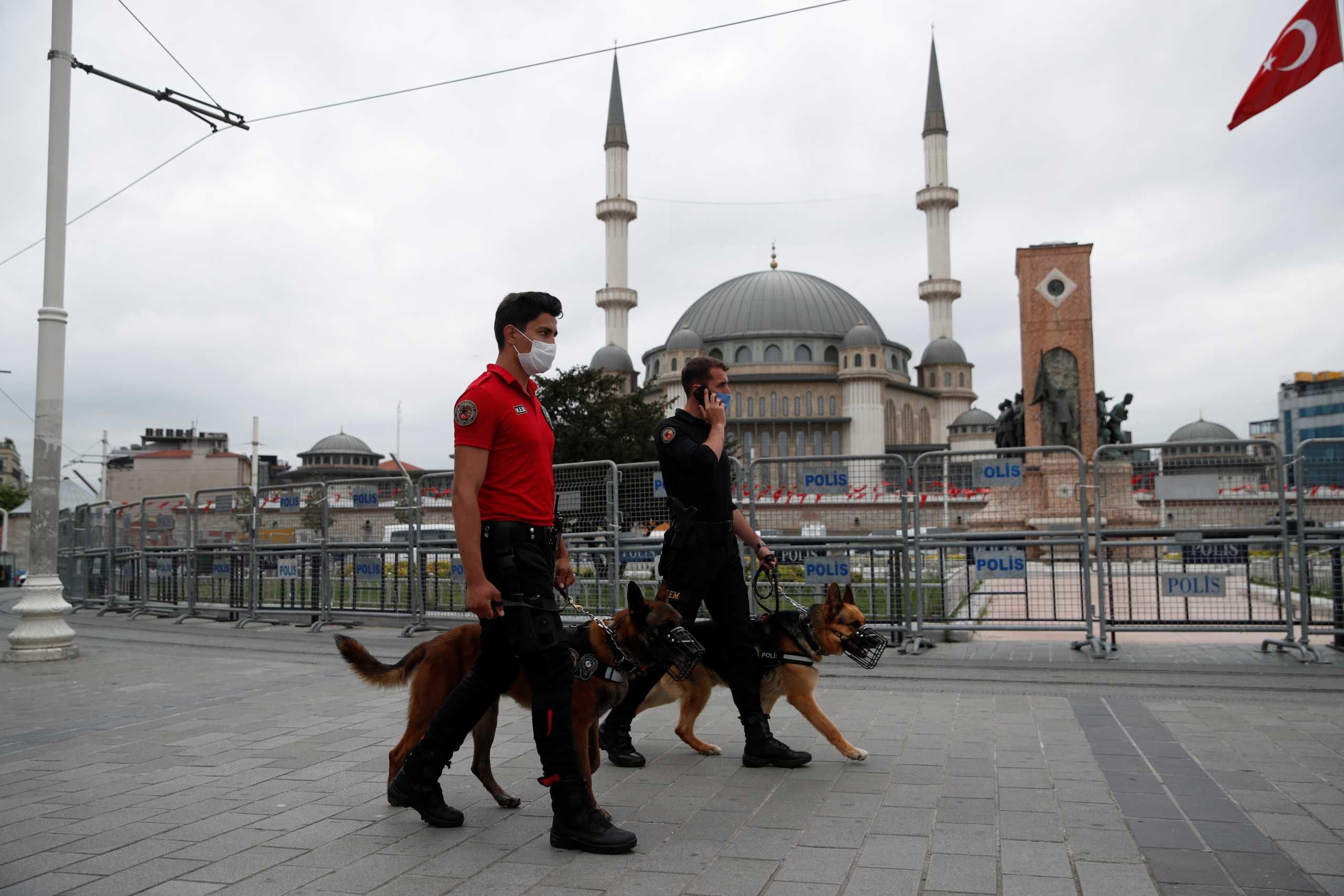 Members of Turkish Police Dog Training Center patrol with a K-9 dogs secure Taksim Square to prevent demonstrators to defy a ban and gather to mark the eighth anniversary of Gezi Park protests, in central Istanbul, Turkey May 31, 2021. REUTERS