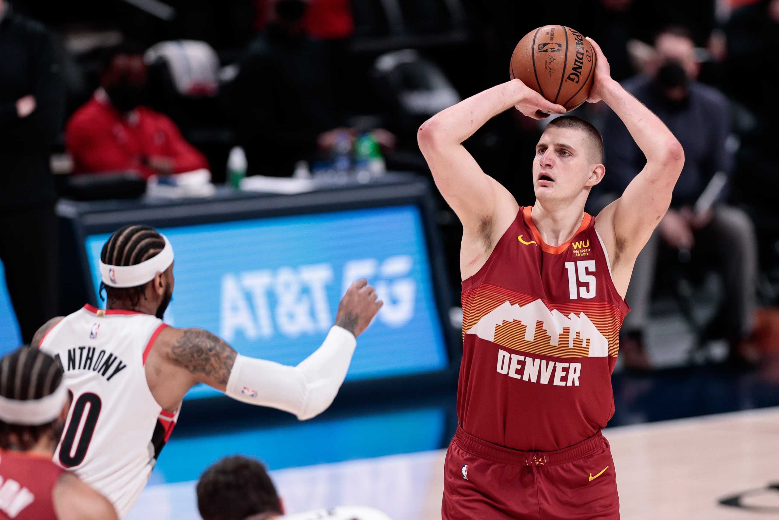 May 24, 2021; Denver, Colorado, USA; Denver Nuggets center Nikola Jokic (15) attempts a shot as Portland Trail Blazers forward Carmelo Anthony (00) defends in the first quarter during game two in the first round of the 2021 NBA Playoffs at Ball Arena. Mandatory Credit: Isaiah J. Downing-USA TODAY Sports
