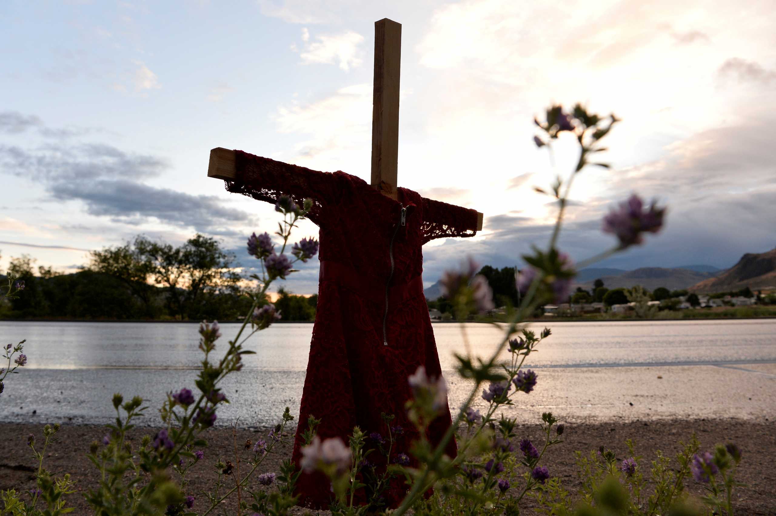FILE PHOTO: A child's red dress hangs on a stake near the grounds of the former Kamloops Indian Residential School in Kamloops, British Columbia, Canada June 5, 2021.  REUTERS