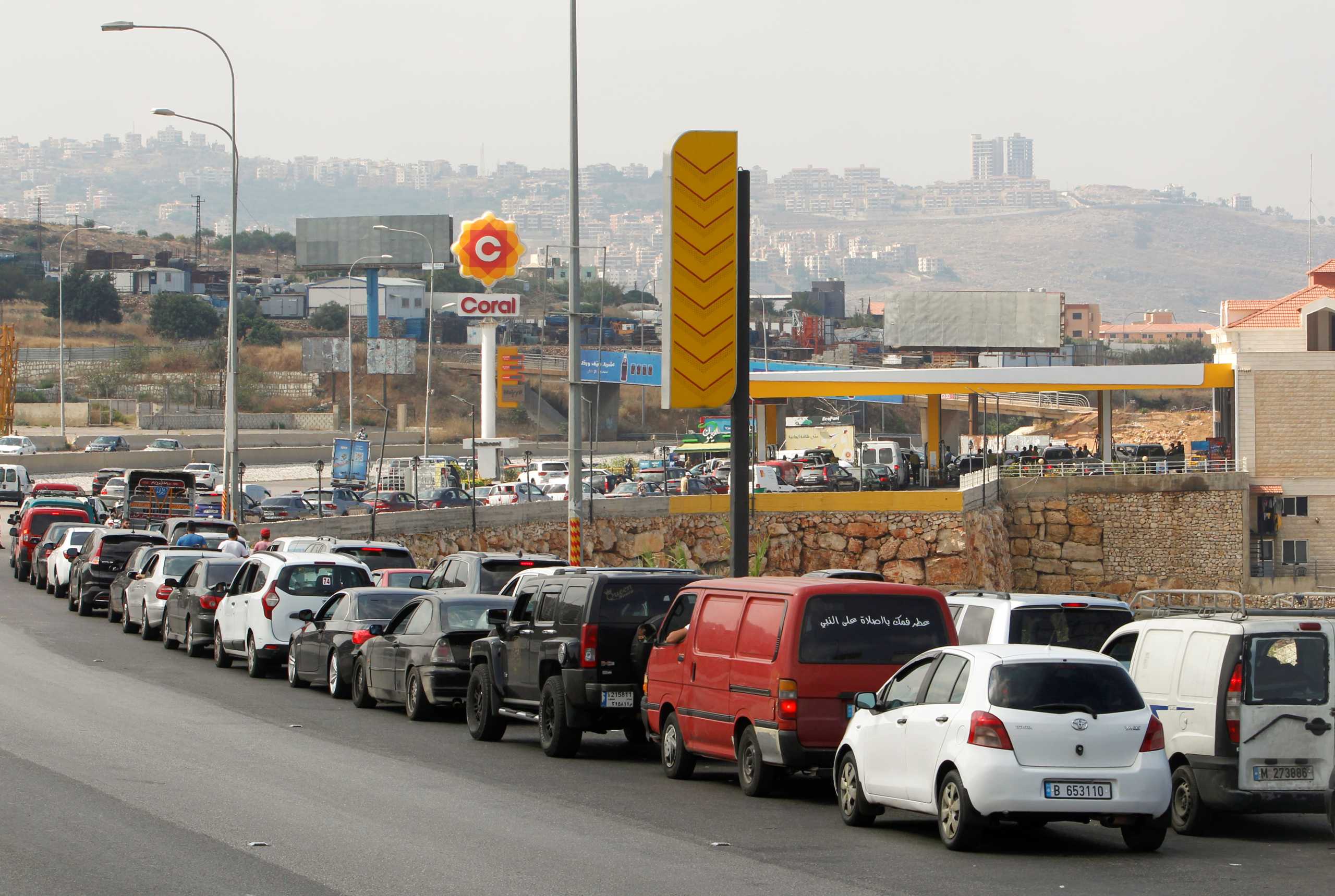 Cars stand in line at a gas station as they wait to fuel up in Damour, Lebanon June 25, 2021. REUTERS