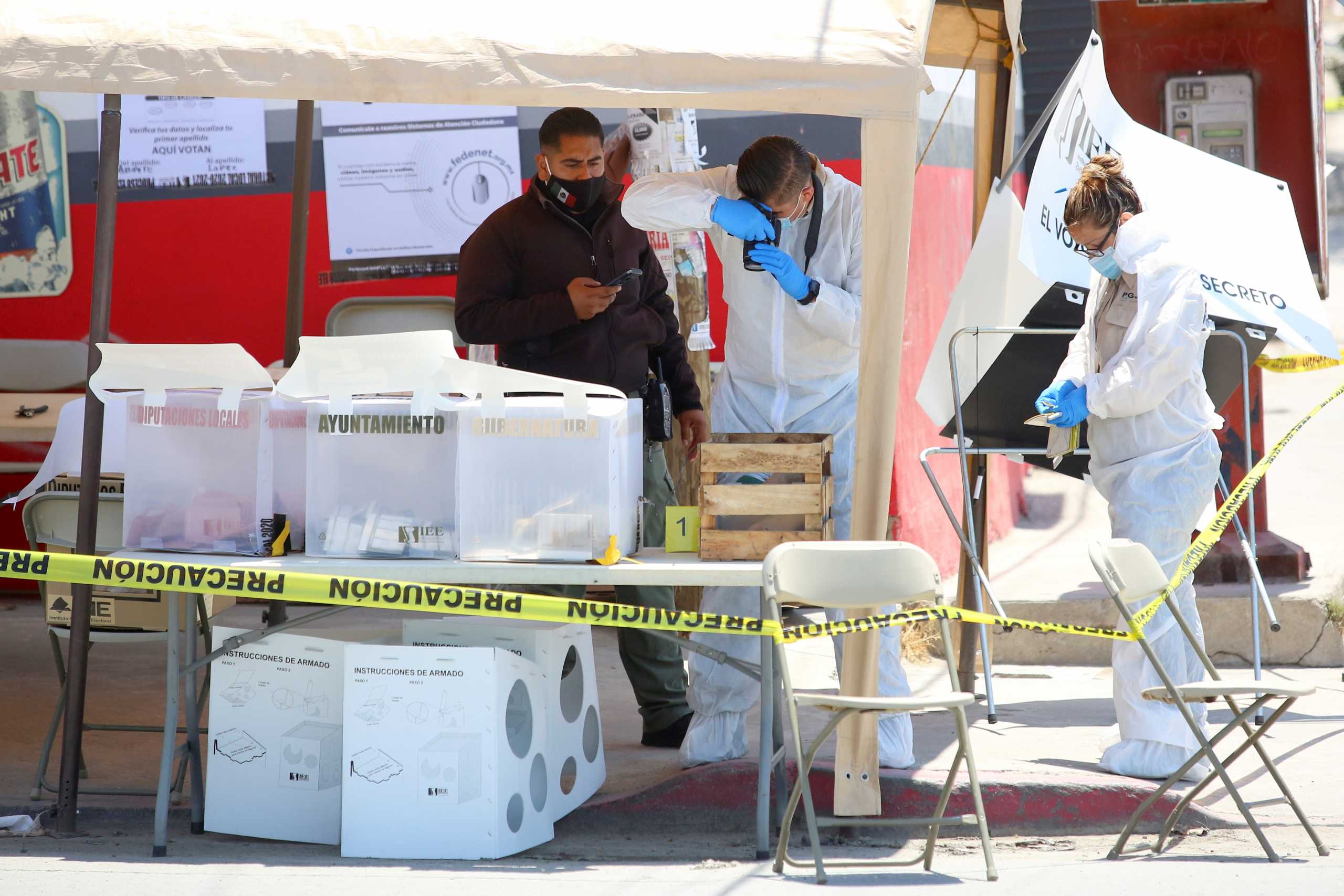 SENSITIVE MATERIAL. THIS IMAGE MAY OFFEND OR DISTURB    Forensic technicians work at a scene in a polling station where a man threw a severed human head, during the mid-term elections in Tijuana, Mexico June 6, 2021. REUTERS