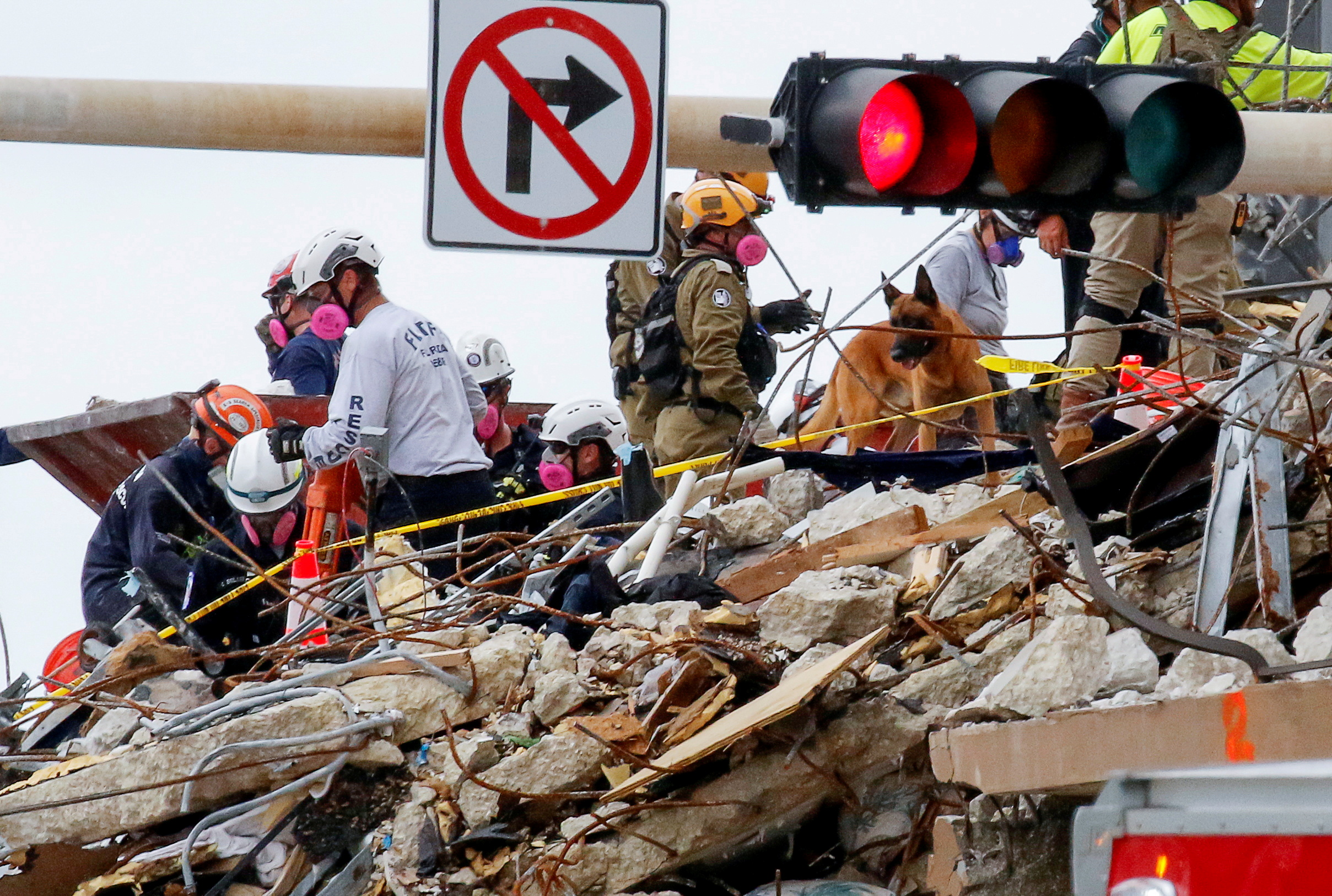 Emergency workers conduct search and rescue efforts at the site of a partially collapsed residential building in Surfside, near Miami Beach, Florida, U.S. June 29, 2021. REUTERS