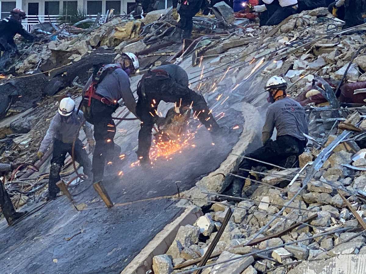 Members of the Urban Search and Rescue Florida Task Force 3 heavy rigging team work at the site of a partially collapsed residential building in Surfside, near Miami Beach, Florida, June 28, 2021. Picture taken June 28, 2021. FLORIDA TASK FORCE 3