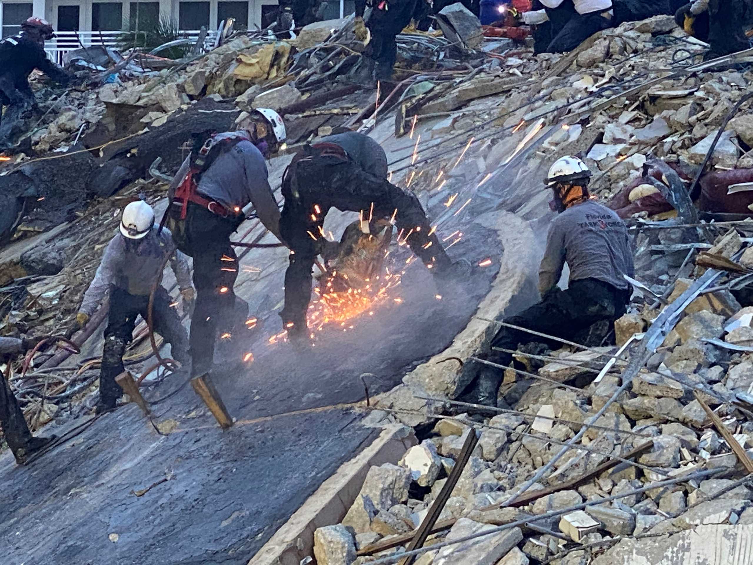 Members of the Urban Search and Rescue Florida Task Force 3 heavy rigging team work at the site of a partially collapsed residential building in Surfside, near Miami Beach, Florida, June 28, 2021. Picture taken June 28, 2021. FLORIDA TASK FORCE 3