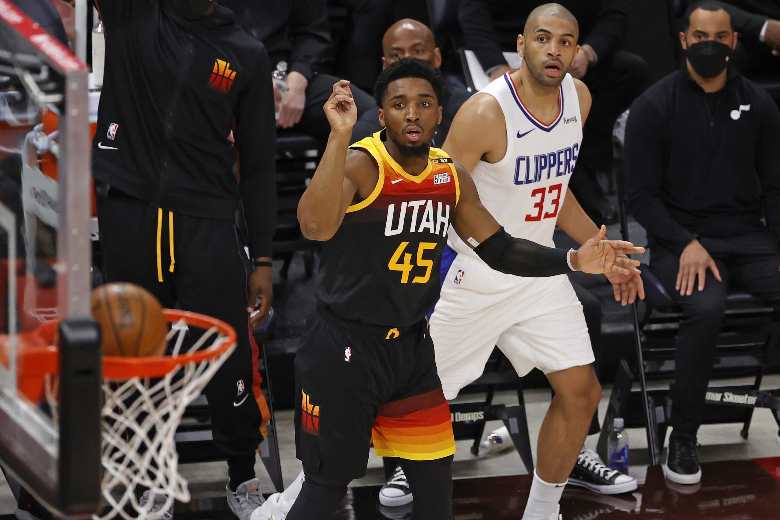 Jun 8, 2021; Salt Lake City, Utah, USA; Utah Jazz guard Donovan Mitchell (45) watches is three-pointer drop against LA Clippers forward Nicolas Batum (33) in the first quarter during game one in the second round of the 2021 NBA Playoffs. at Vivint Arena. Mandatory Credit: Jeffrey Swinger-USA TODAY Sports